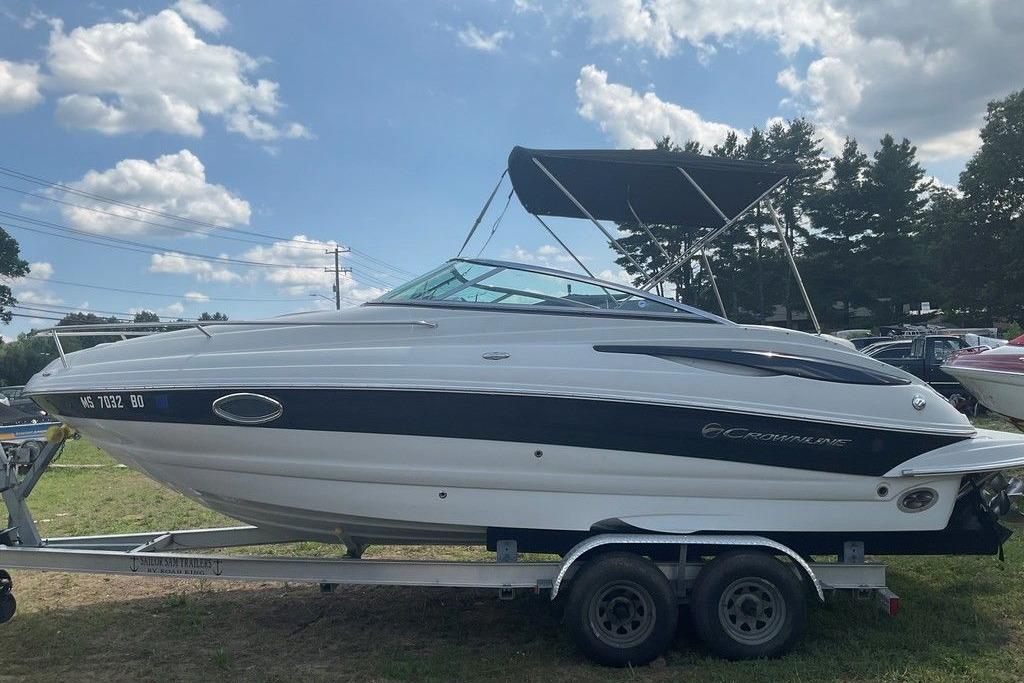 2015 Crownline 236 SC boat on trailer under blue sky.