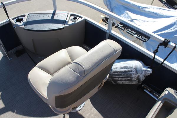 2024 Sun Tracker BB18 boat interior with beige seating and control panel.