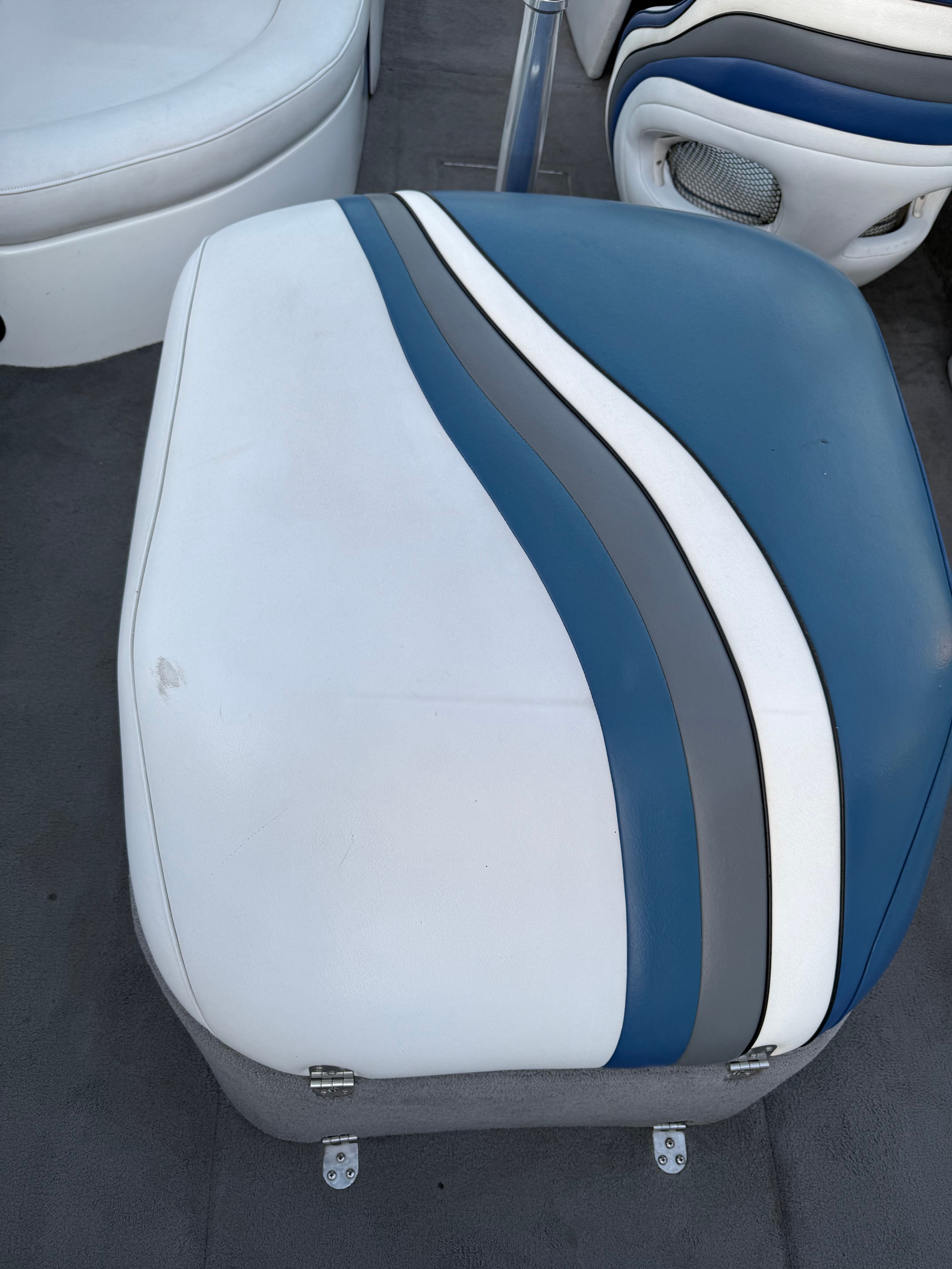 Seat cushion of a 2004 MB Sports 220 boat with blue-white stripes.