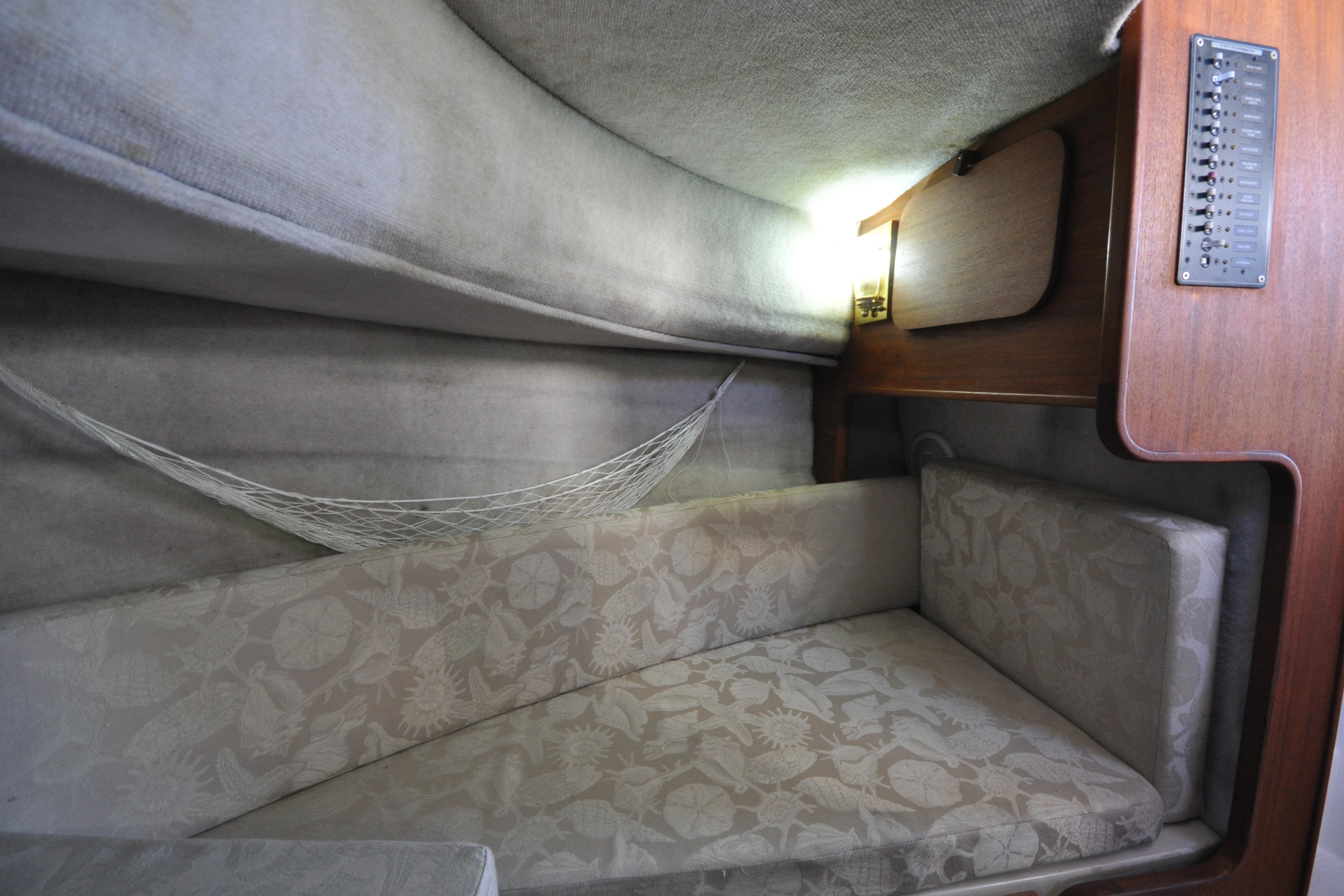 Cozy interior cabin of 2007 Ranger Tug R-25 with cushioned seating and net storage.