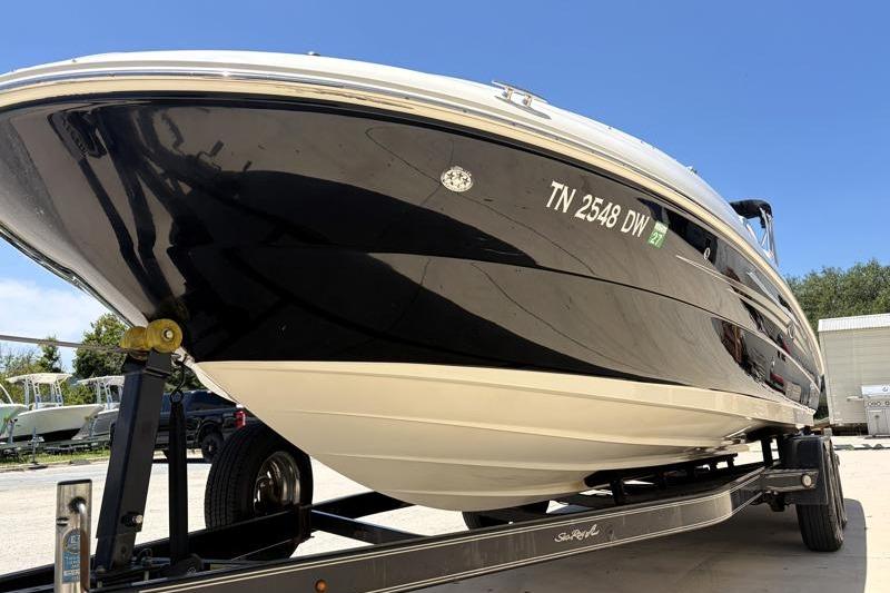 2007 Sea Ray 240 Sundeck boat on trailer, black hull, sunny day.