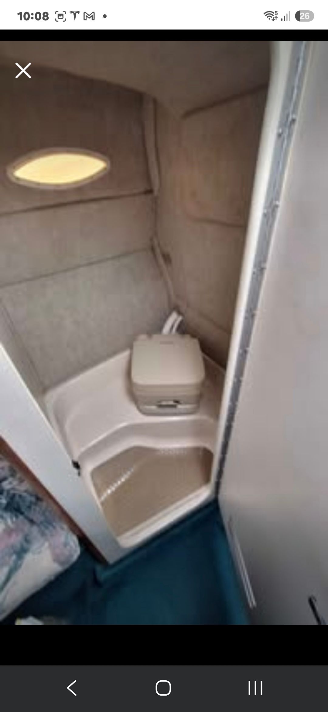 Interior of the 1998 Sea Ray 240 Sundancer featuring a small toilet.