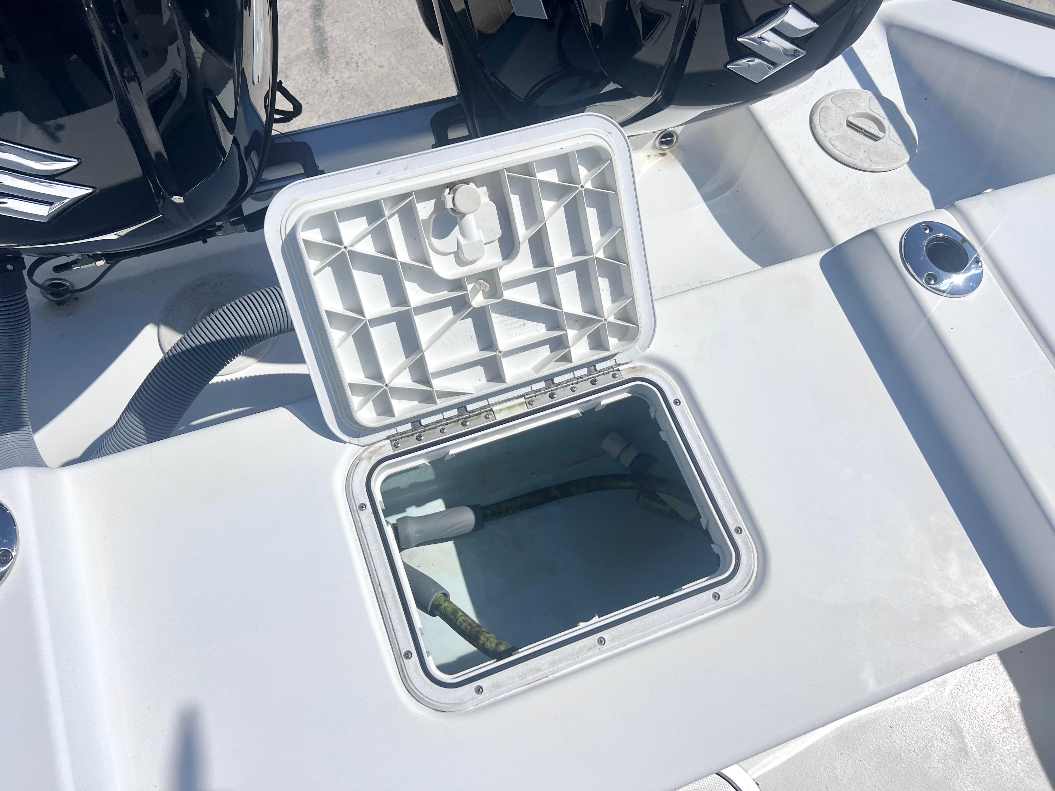 Open hatch on 2022 Cape Horn 24 XS boat deck, revealing storage compartment.