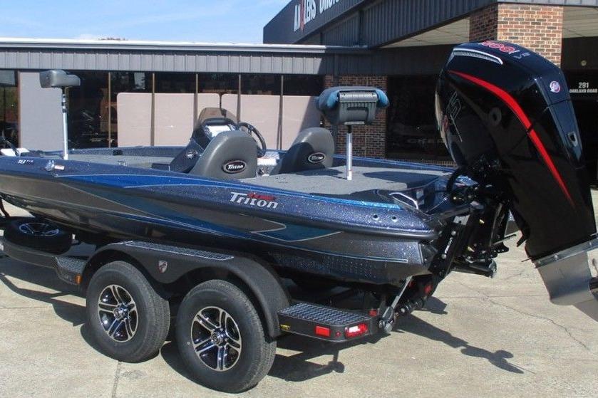 2026 Triton 18 TrX boat on trailer, parked outside a building.