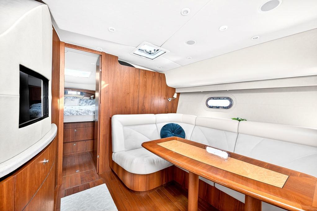 Luxurious interior of 2006 Tiara Yachts 4300 Sovran with elegant wood and leather seating.