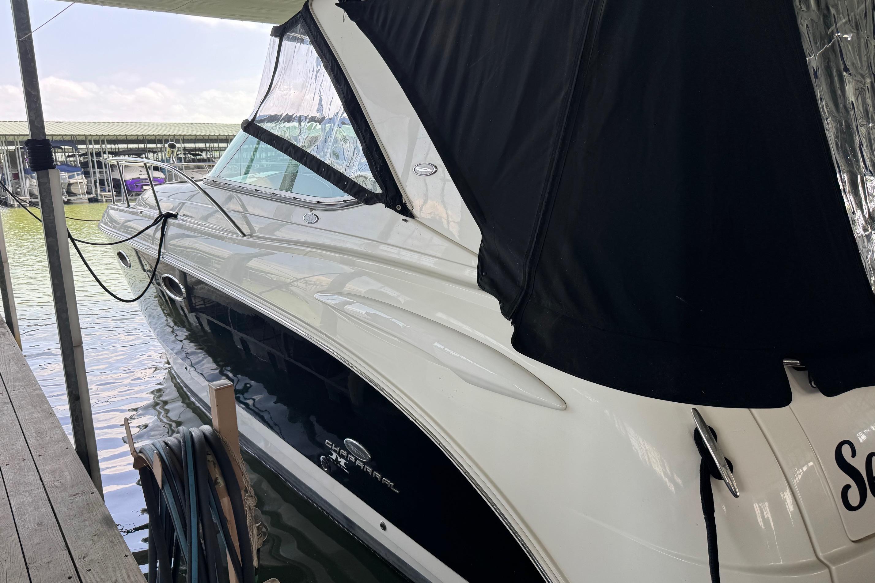 2006 Chaparral 330 Signature boat docked with black canopy cover.