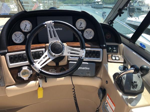 The cockpit of a 2008 Four Winns V338 with a modern steering wheel and instruments.