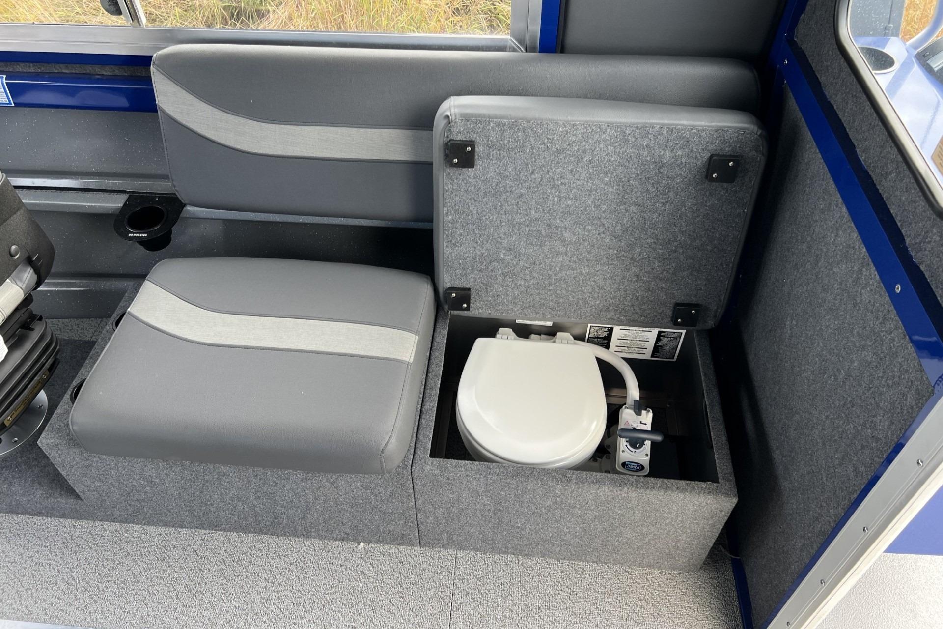 2024 Spartan 26 Maximus Pro XL interior with hidden toilet under seat.
