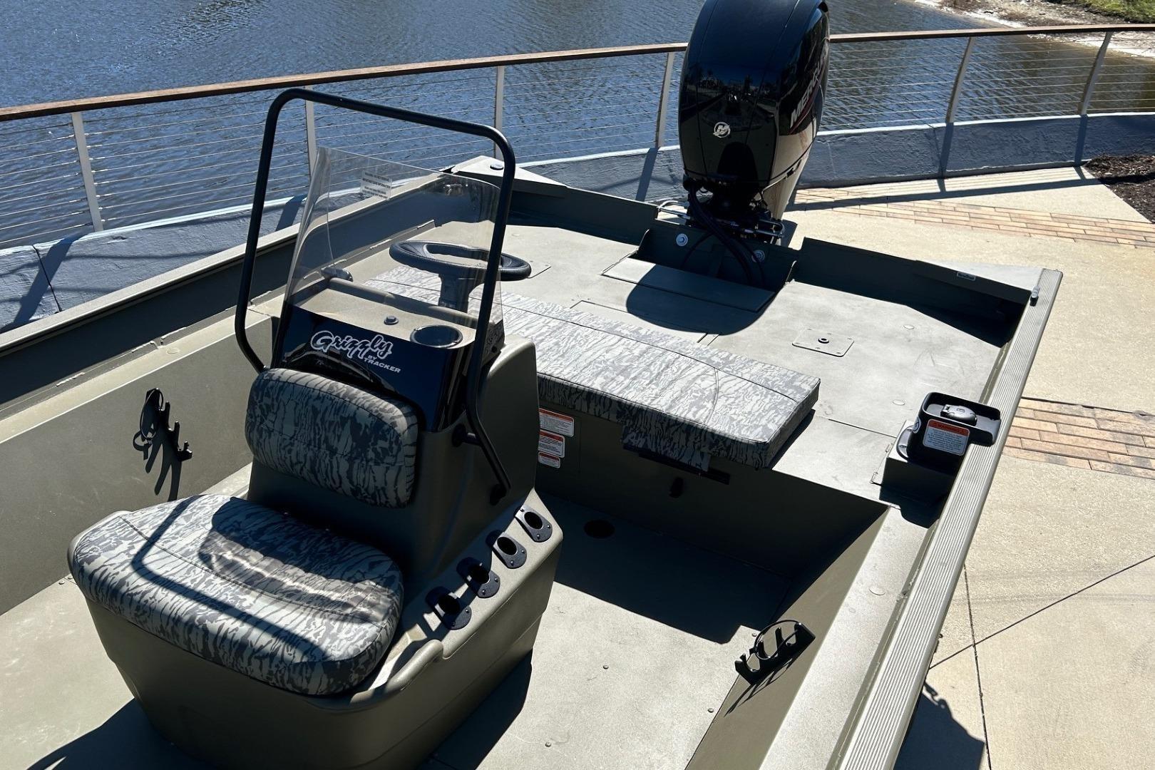 Tracker Grizzly 2072 CC 2026 boat by the water.