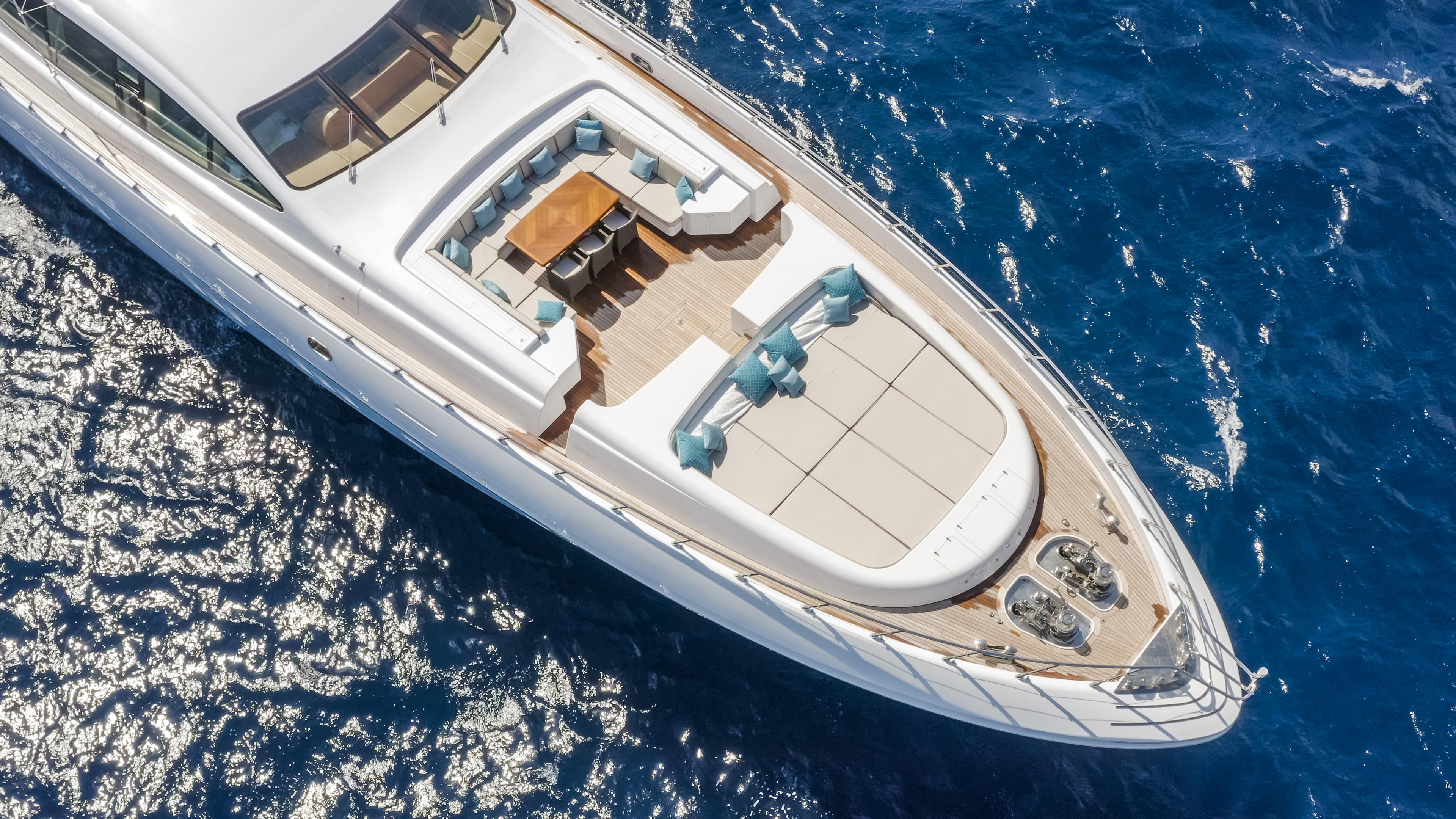 Luxurious 2011 Mangusta 165 yacht cruising on vibrant blue ocean waters.