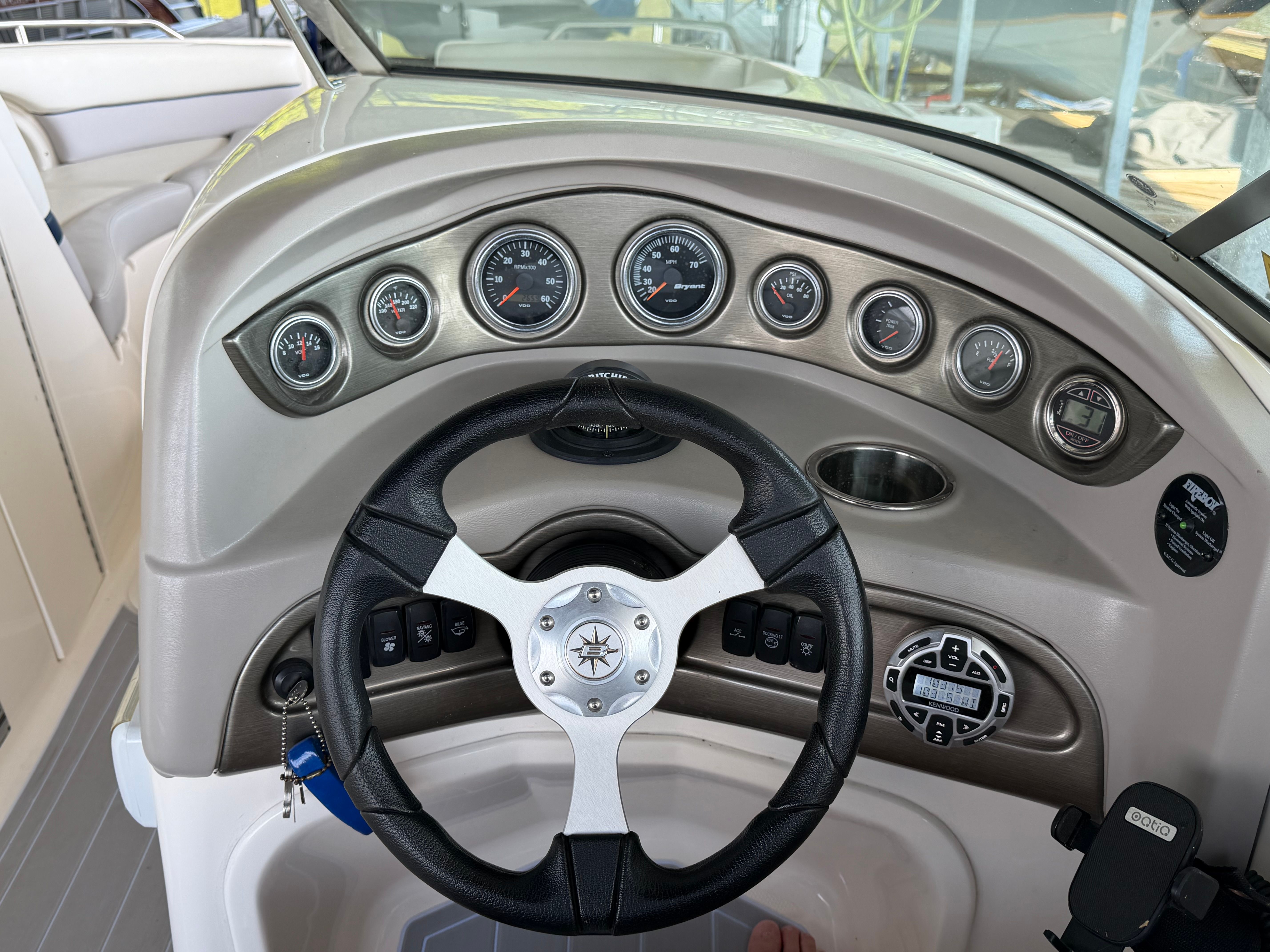 Dashboard of a 2010 Bryant 255 boat with steering wheel and gauges.