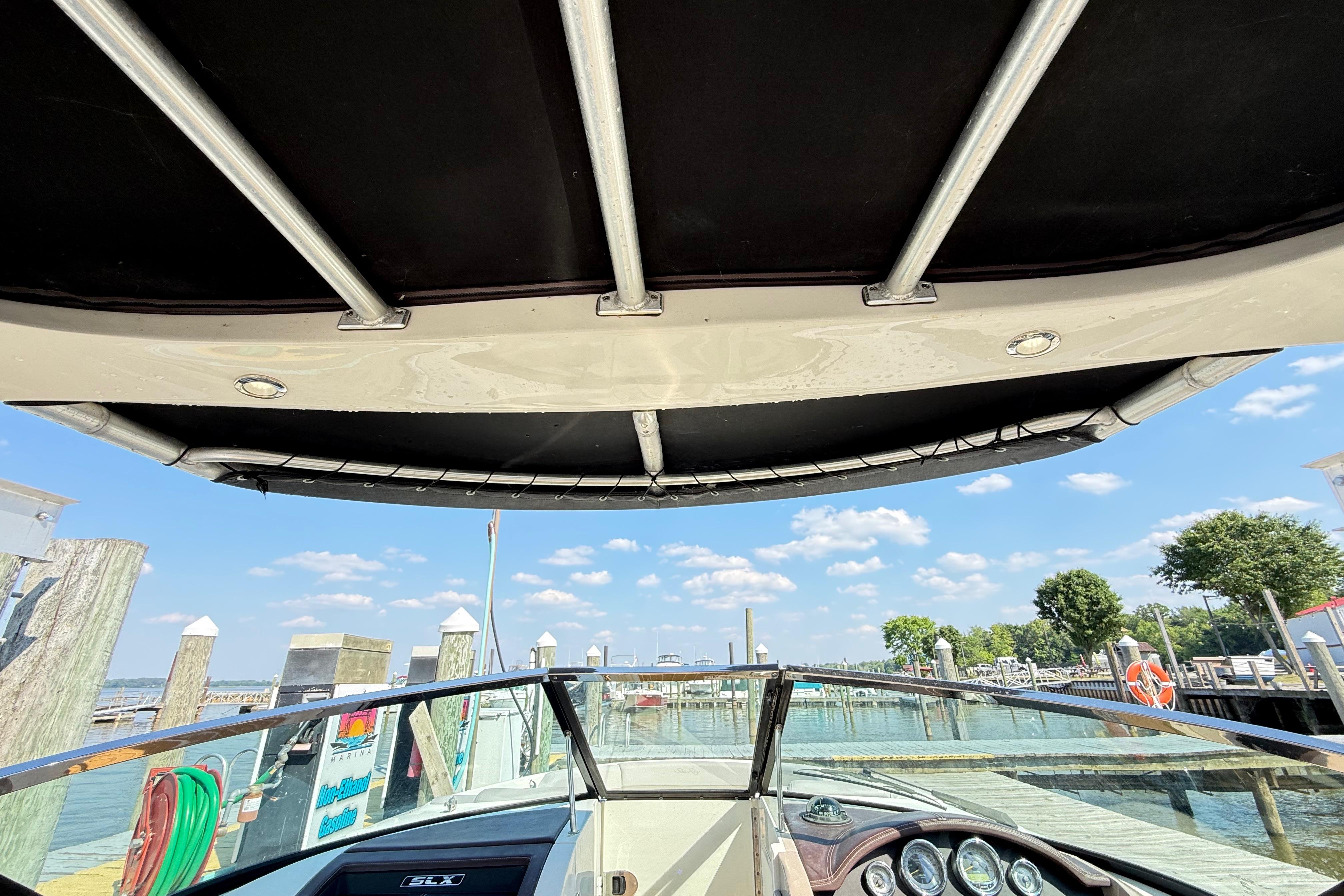 2011 Sea Ray 270 SLX boat interior view at a sunny marina.
