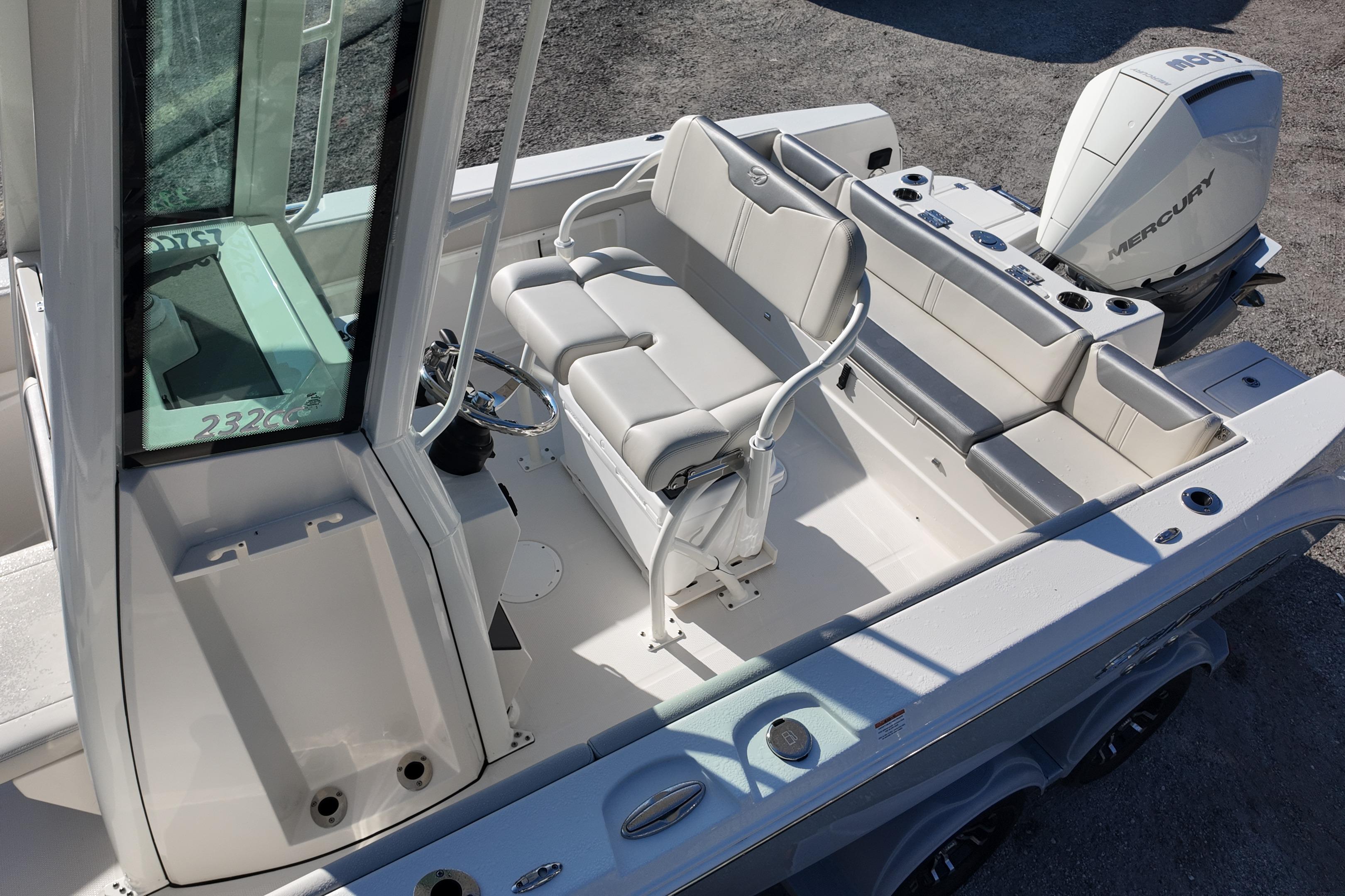 2026 Sailfish 232 CC boat interior with seating and Mercury outboard engine.