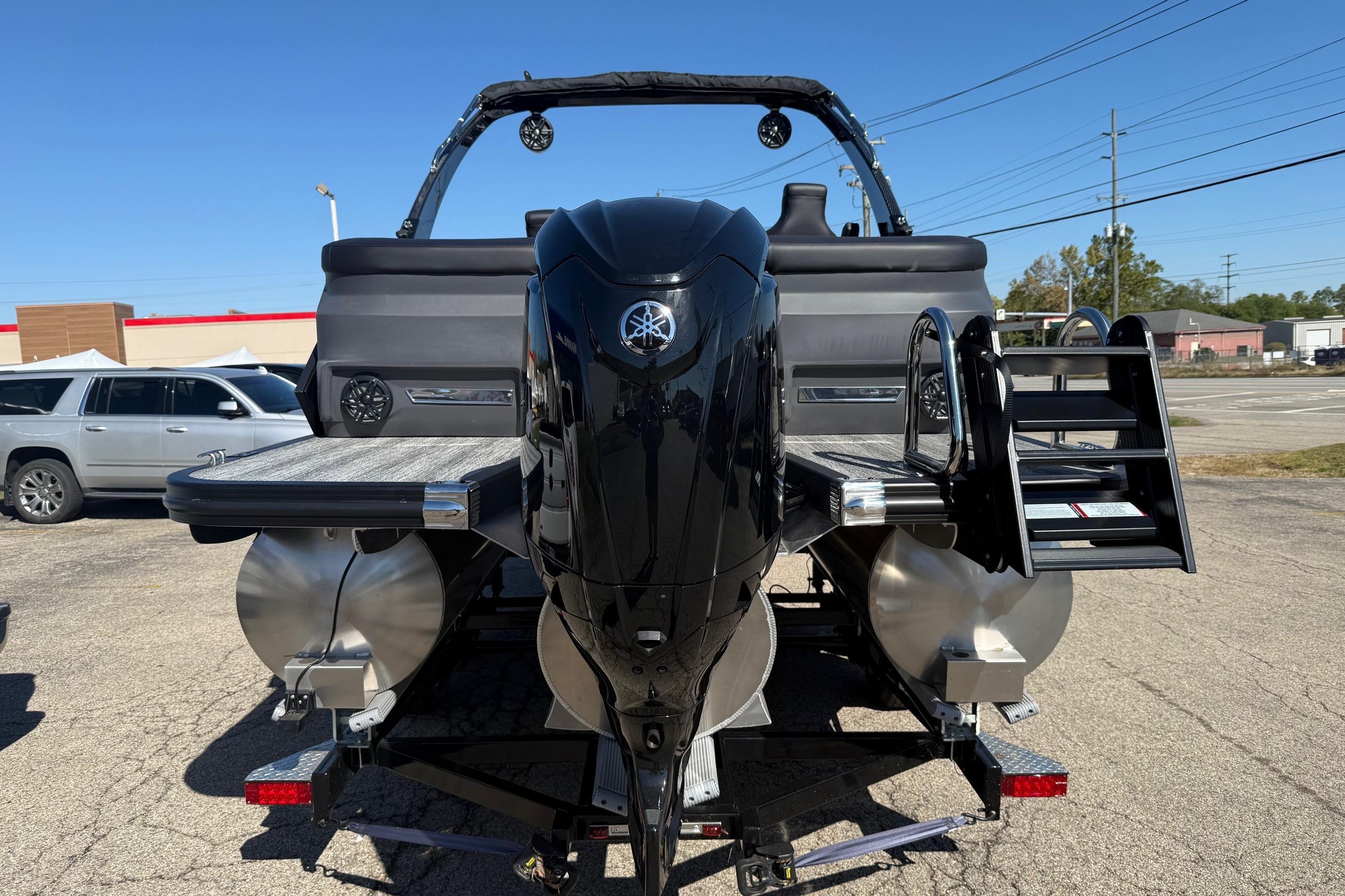2025 Bennington M Line pontoon boat with Yamaha outboard motor, parked on a trailer.