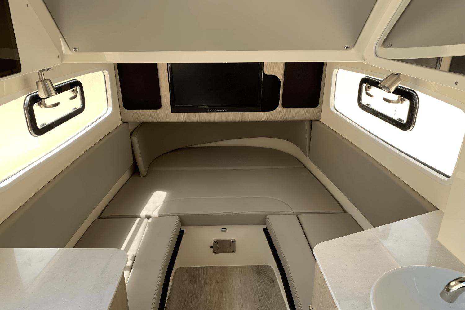 2024 Scout 357LXF cabin interior with seating, windows, and TV.