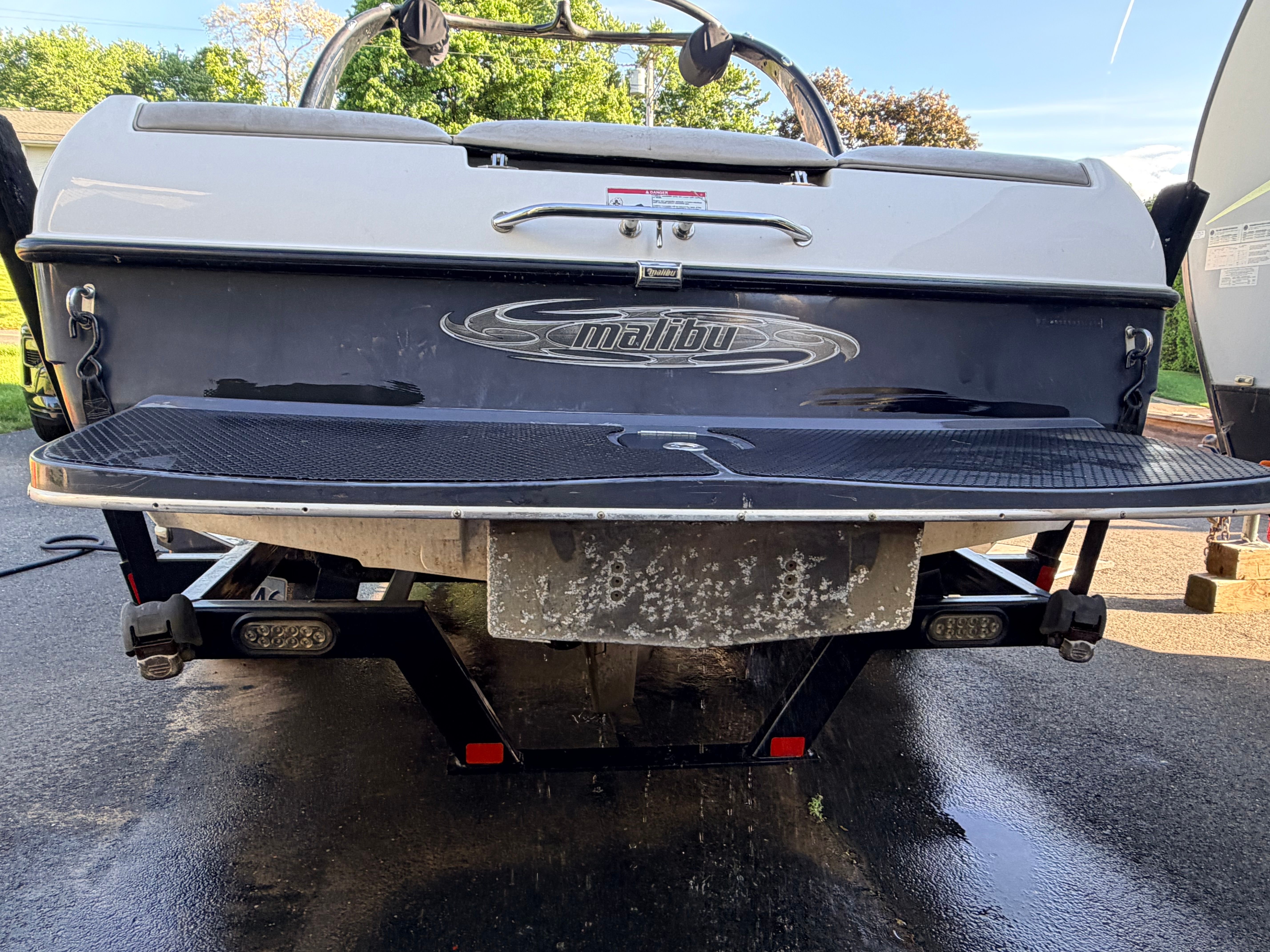 Rear view of a 2006 Malibu iRide boat on a trailer.