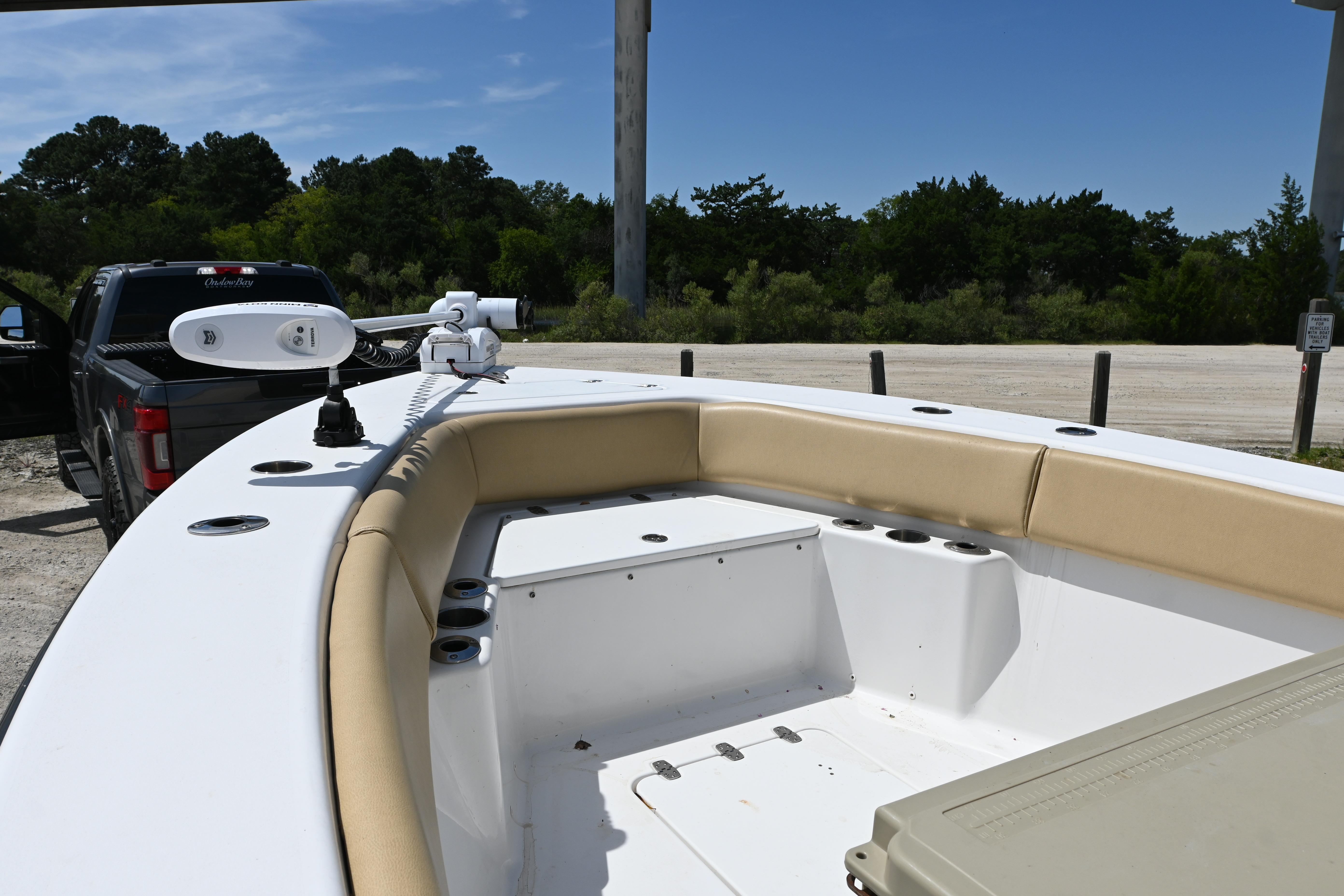 2023 Clark Sound 24 boat interior with tan seating, parked near a truck.