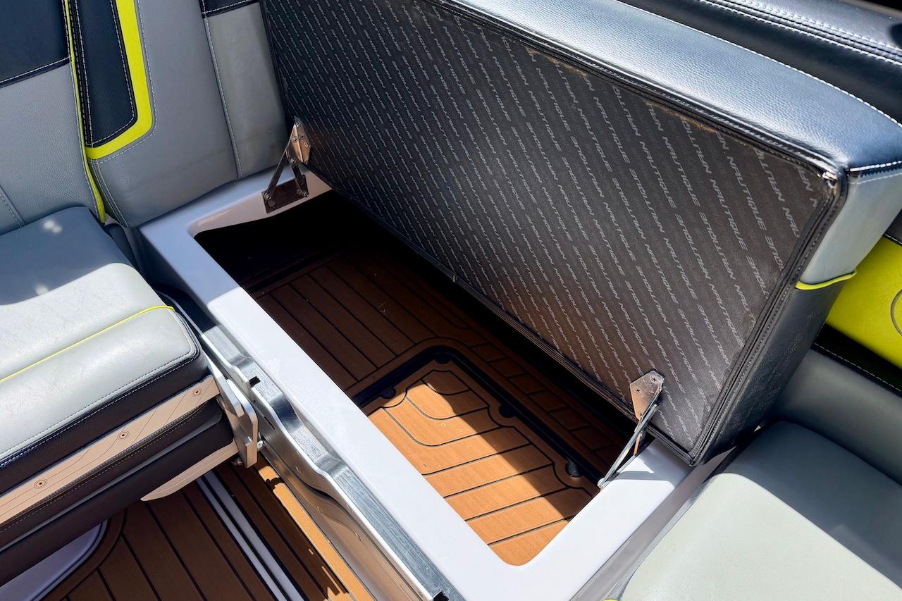 2014 Nautique Super Air Nautique G21 boat seat storage compartment open.