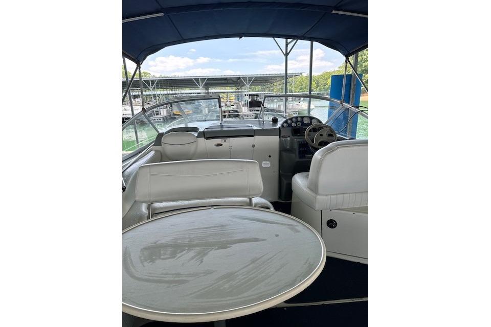 2003 Bayliner 2655 Ciera boat interior with seating and helm, docked at marina.