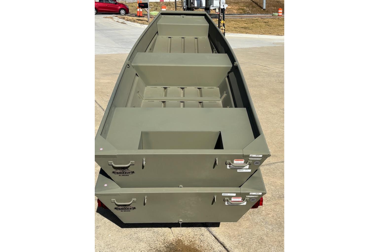 2025 Tracker Grizzly 14 Jon boat, olive green, parked on concrete surface.
