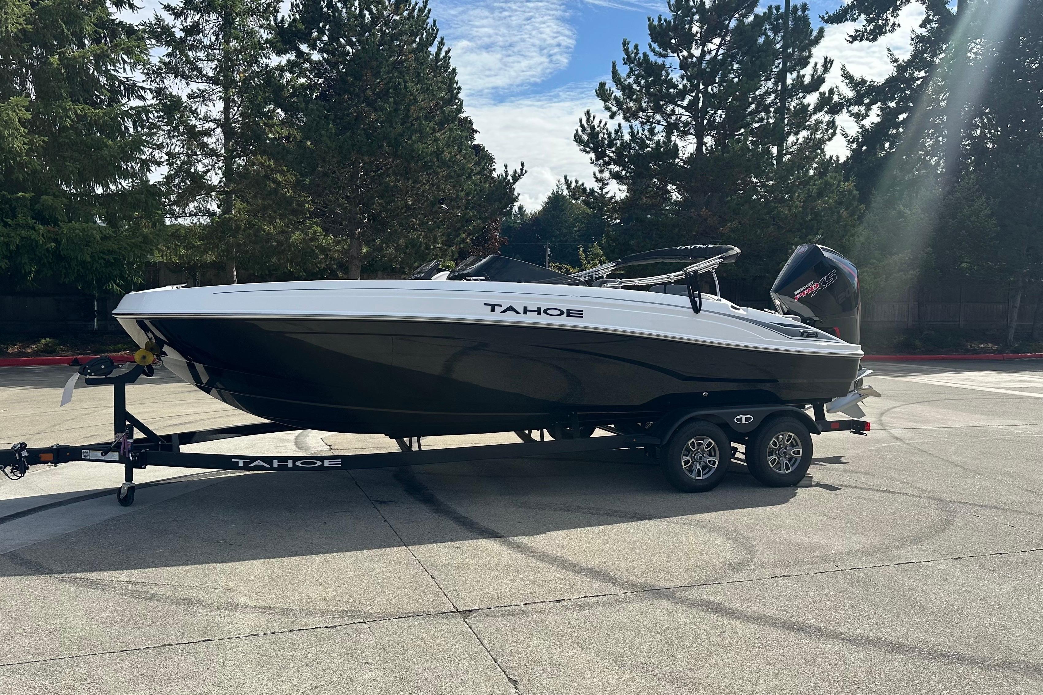 2026 Tahoe T21 boat on trailer, parked outdoors with trees in background.