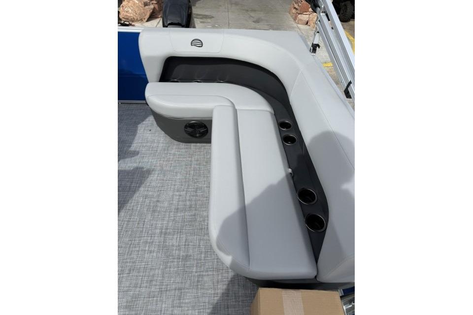 2026 Sun Tracker Party Barge 16 DLX pontoon boat seating with cup holders.