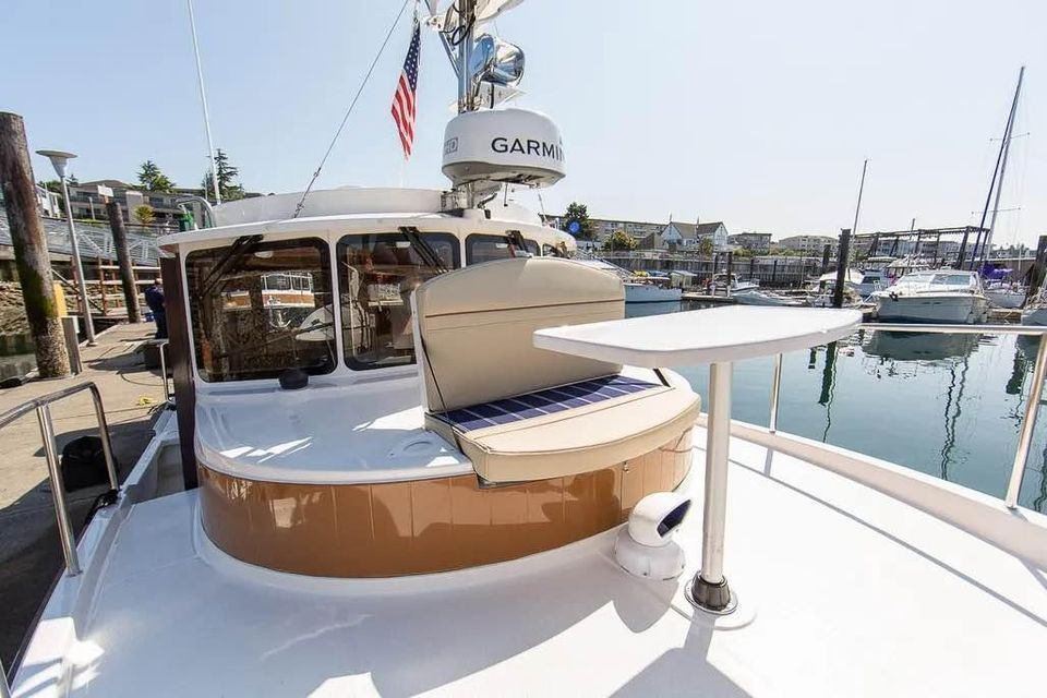 Ranger Tugs R 31 LE 2023 at dock with table and seating area.