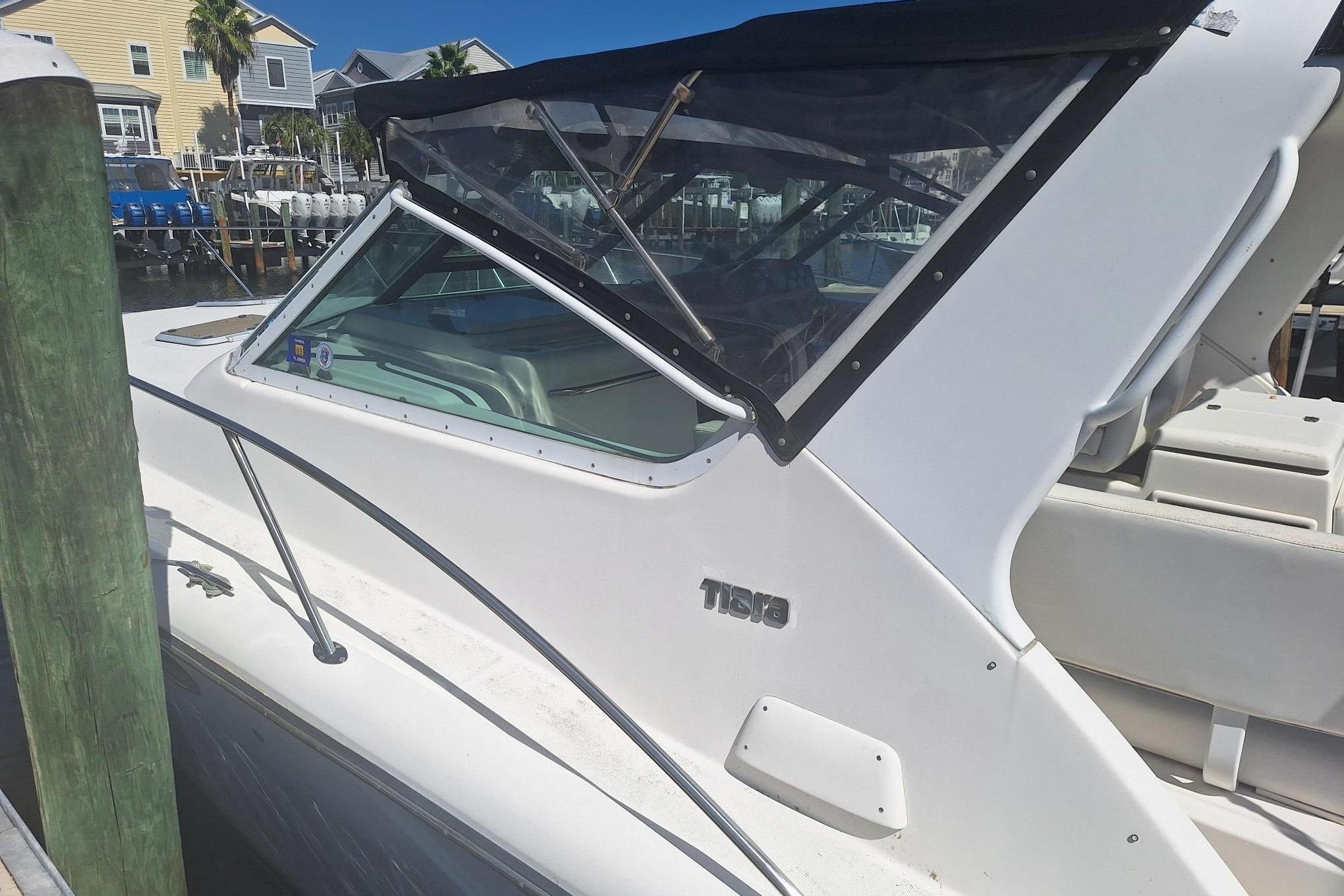 2002 Tiara Yachts 3500 Open docked, featuring sleek white design and covered cockpit.