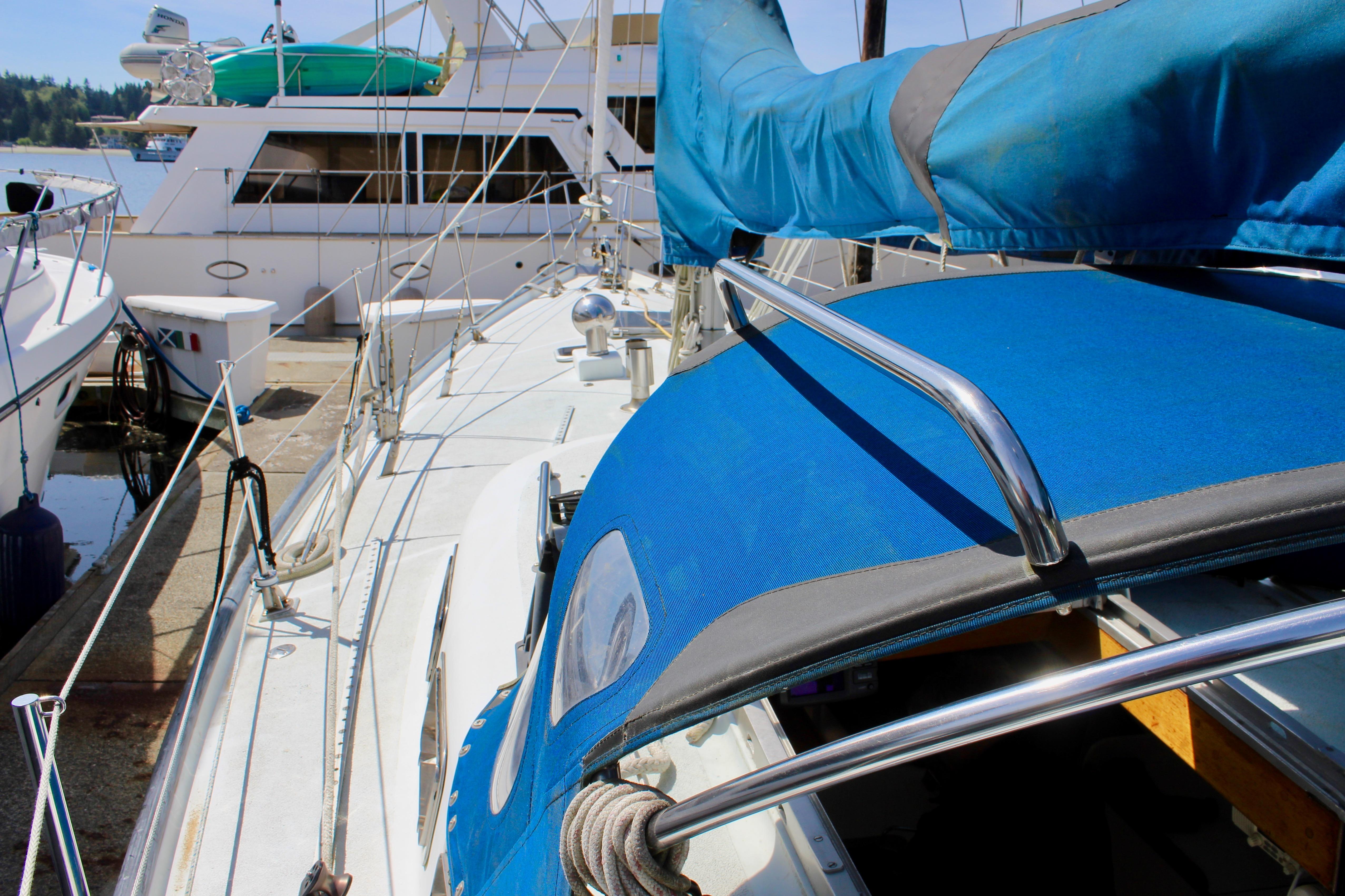 Sailboat Freya 39, 1993 model, docked with blue canopy and polished rails.