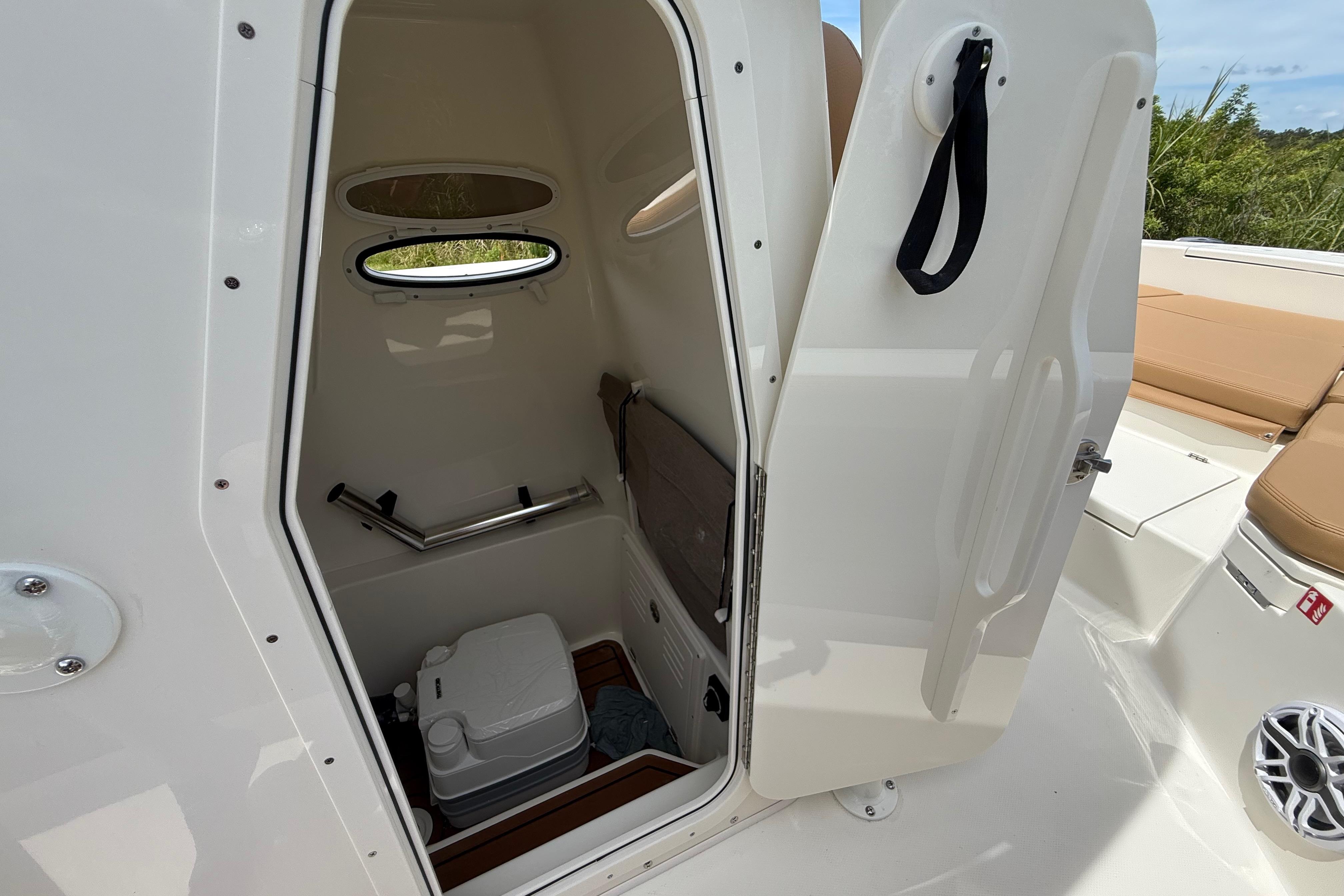 2026 Pathfinder 2400 TRS boat interior with open door and portable toilet.