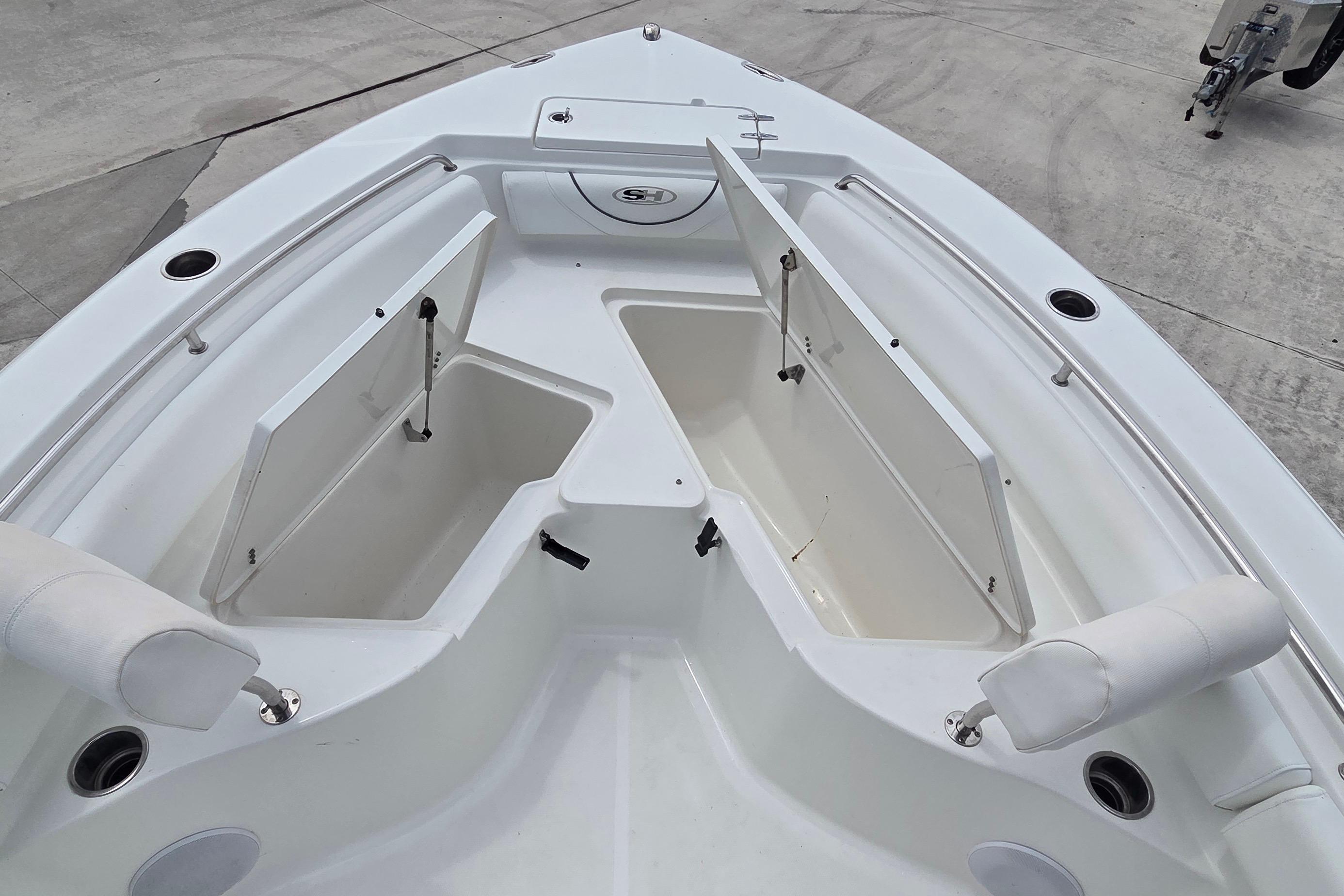 2017 Sea Hunt Ultra 225 boat with open storage compartments on deck.