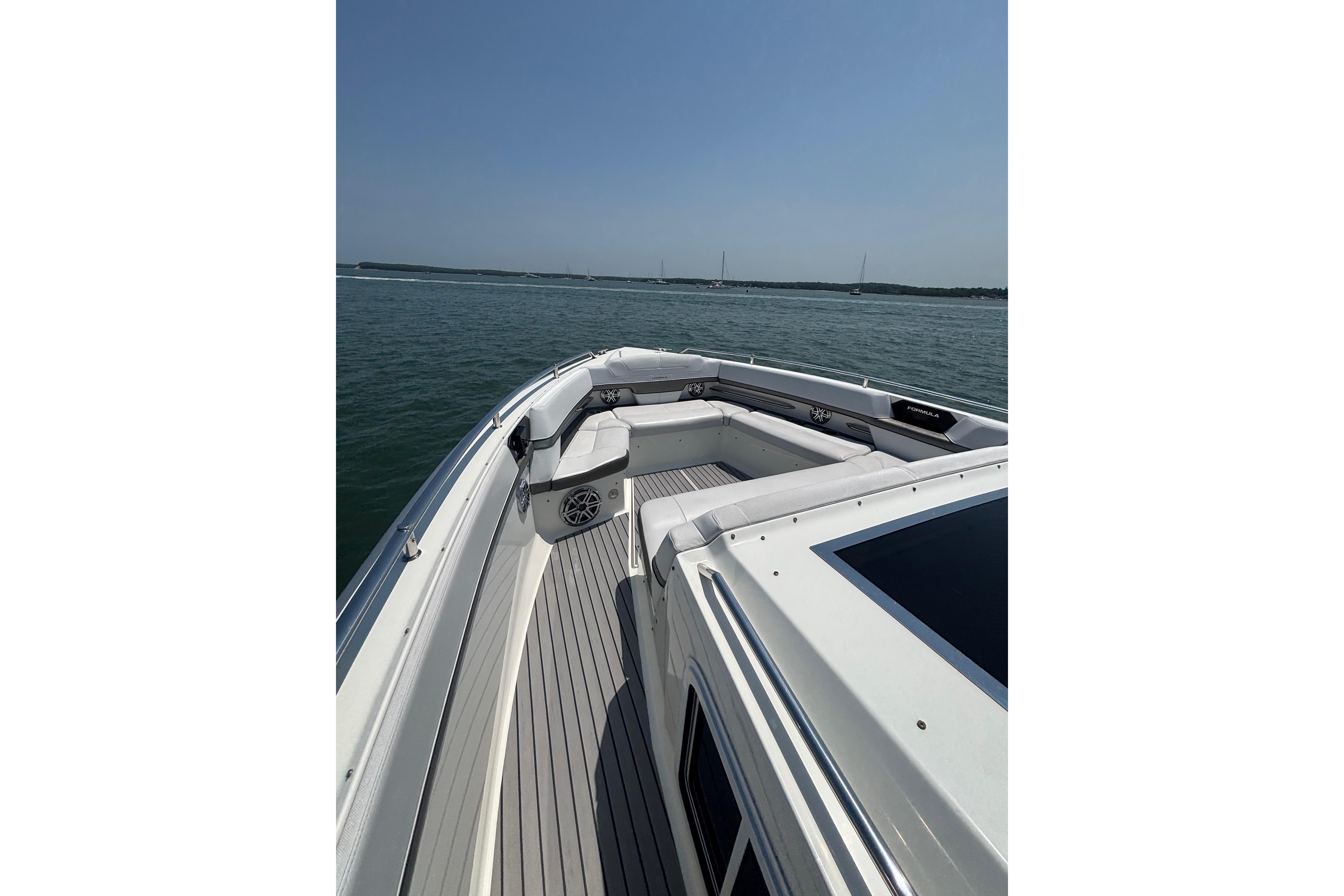 2019 Formula 430 Super Sport Crossover boat on calm water, featuring spacious deck seating.