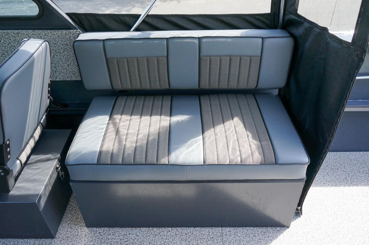 2026 Alumaweld X202 Stryker boat interior seating with gray upholstery and storage compartment.