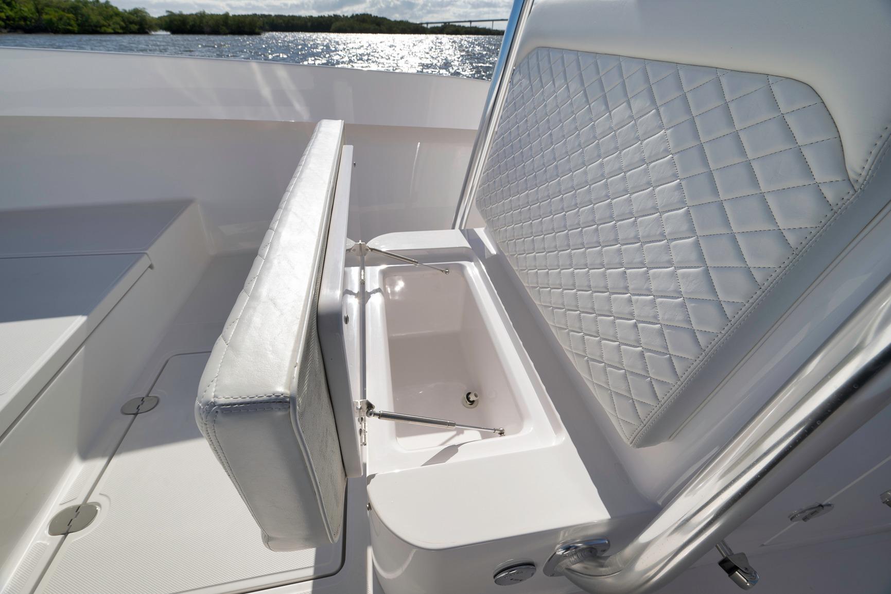 2024 Bahama 41 RD boat with luxurious seating and storage, overlooking serene water.
