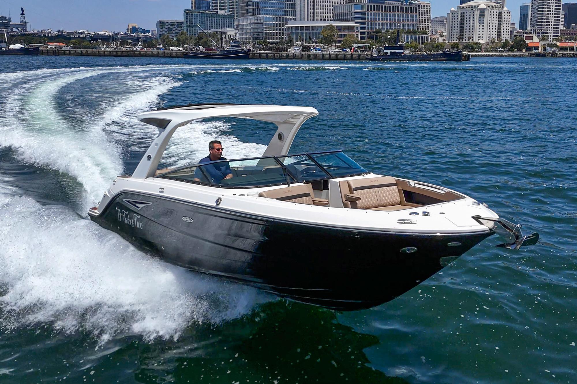 2018 Sea Ray SLX 310 cruising on water near city skyline.