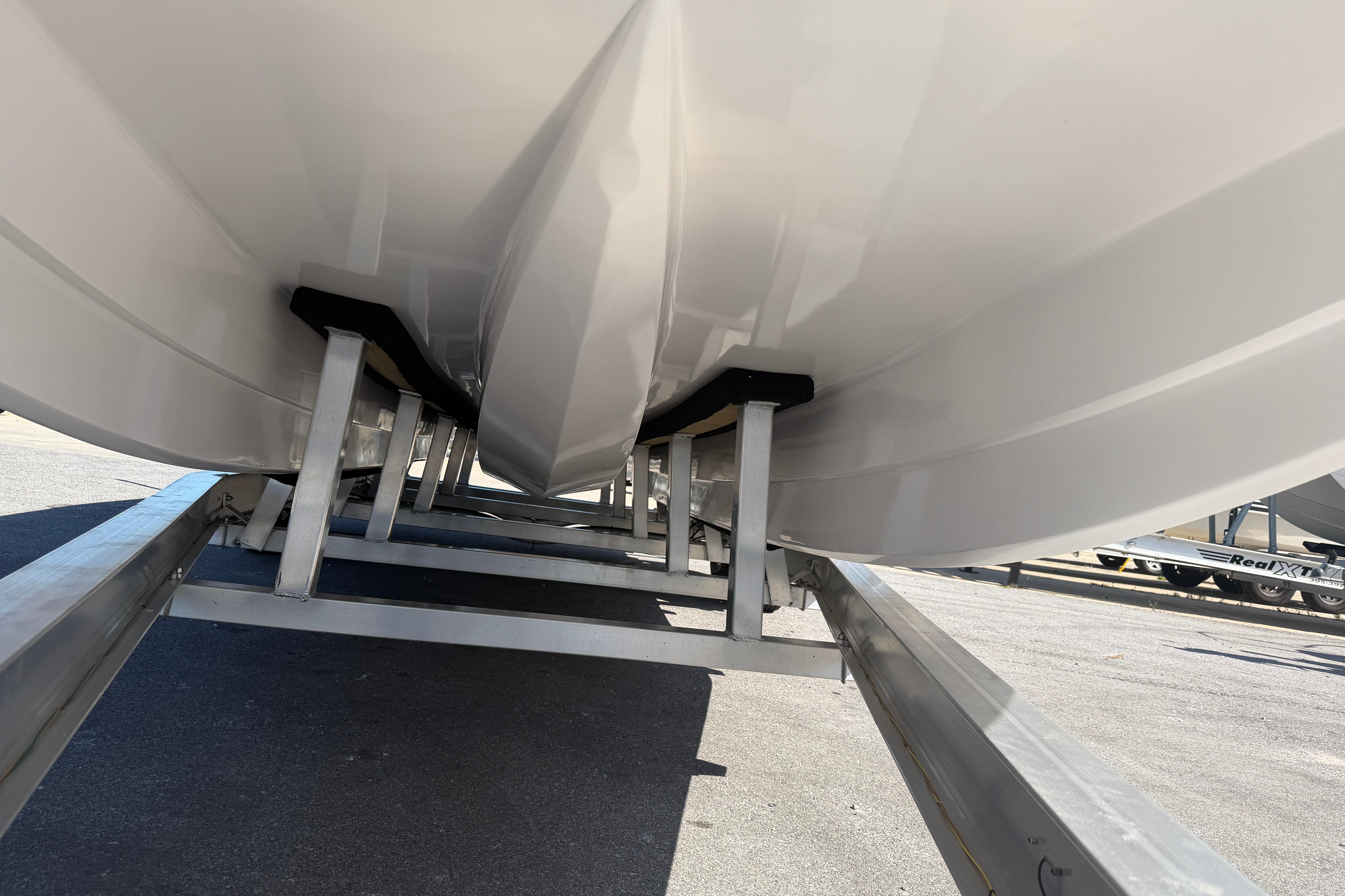 Underneath view of 2026 Skuta 24 Cat boat on a trailer.