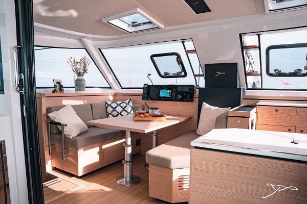 Luxurious interior of 2025 Nautitech 40 Open catamaran with modern seating and navigation equipment.