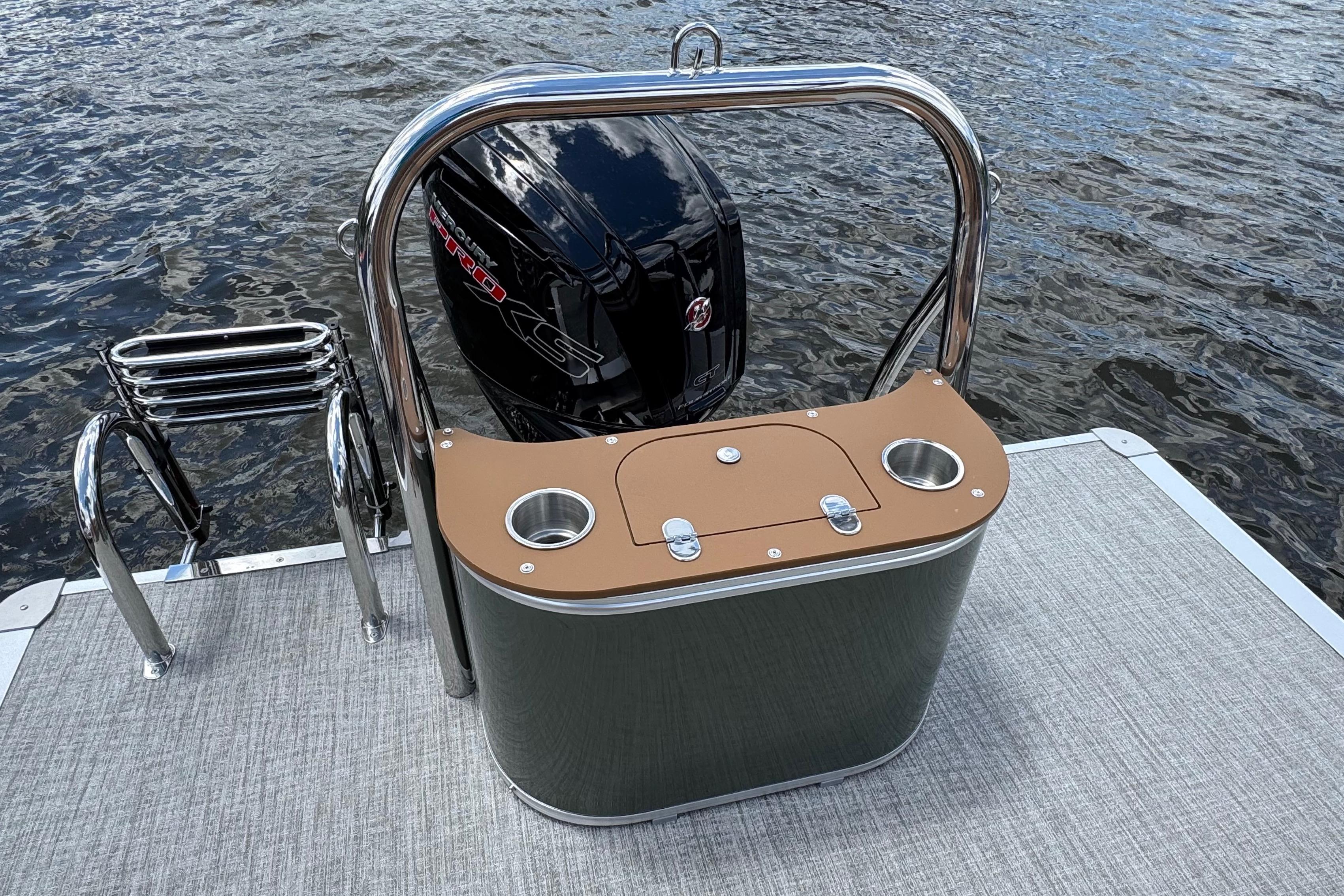 2026 Tahoe Pontoon Sport 85 Cruise Rear Bench 23 with motor and swim ladder on water.