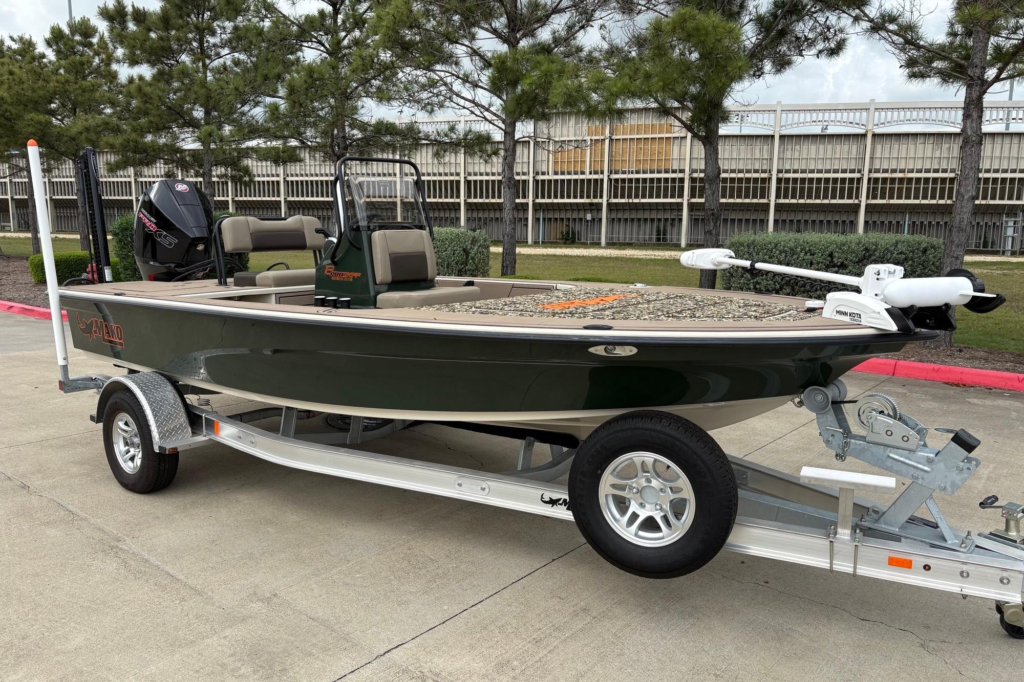 2025 Mako 18 Pro Skiff Backwater Edition boat on trailer, parked outdoors.
