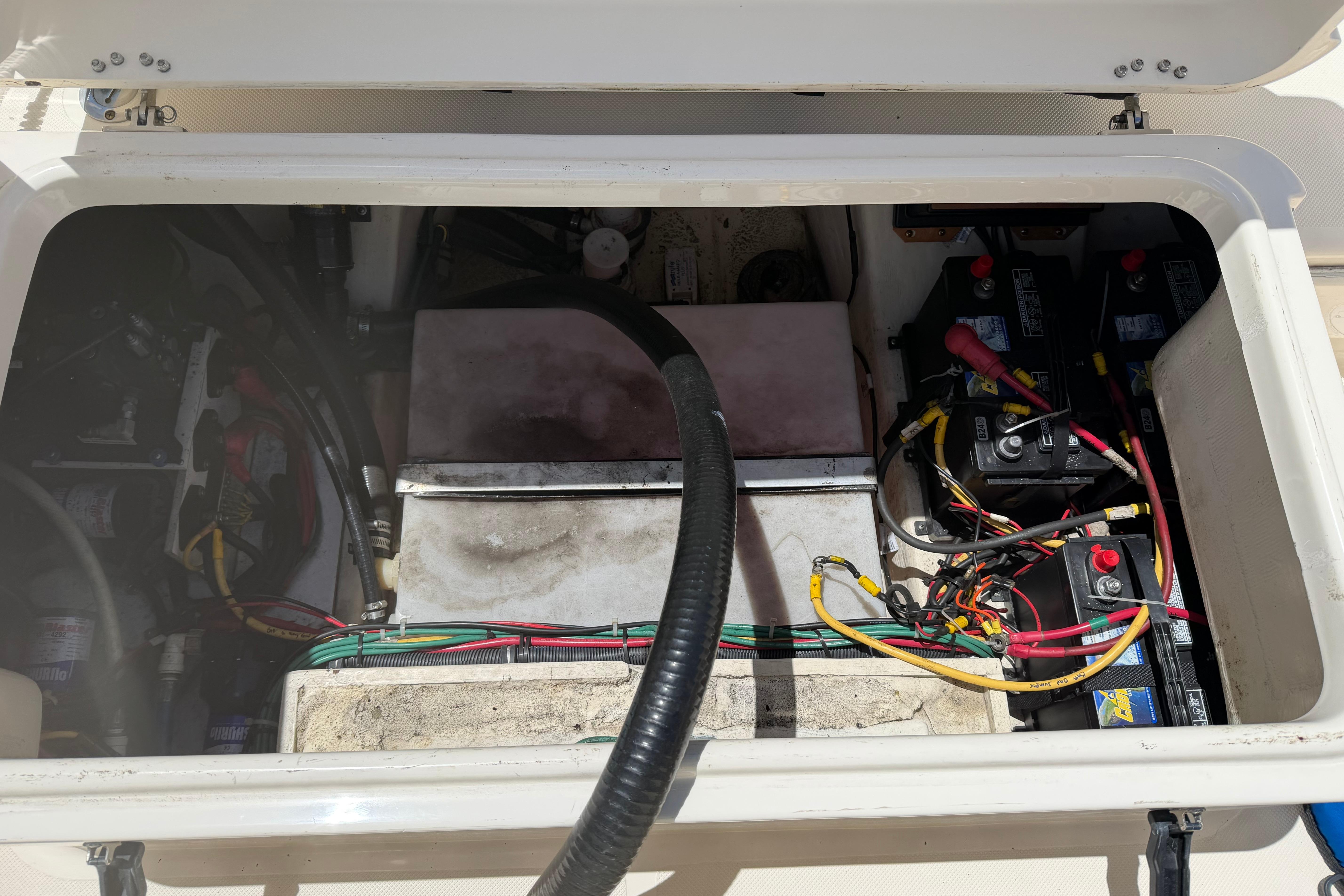 2010 Pursuit OS 255 Offshore boat battery compartment with wiring and components.