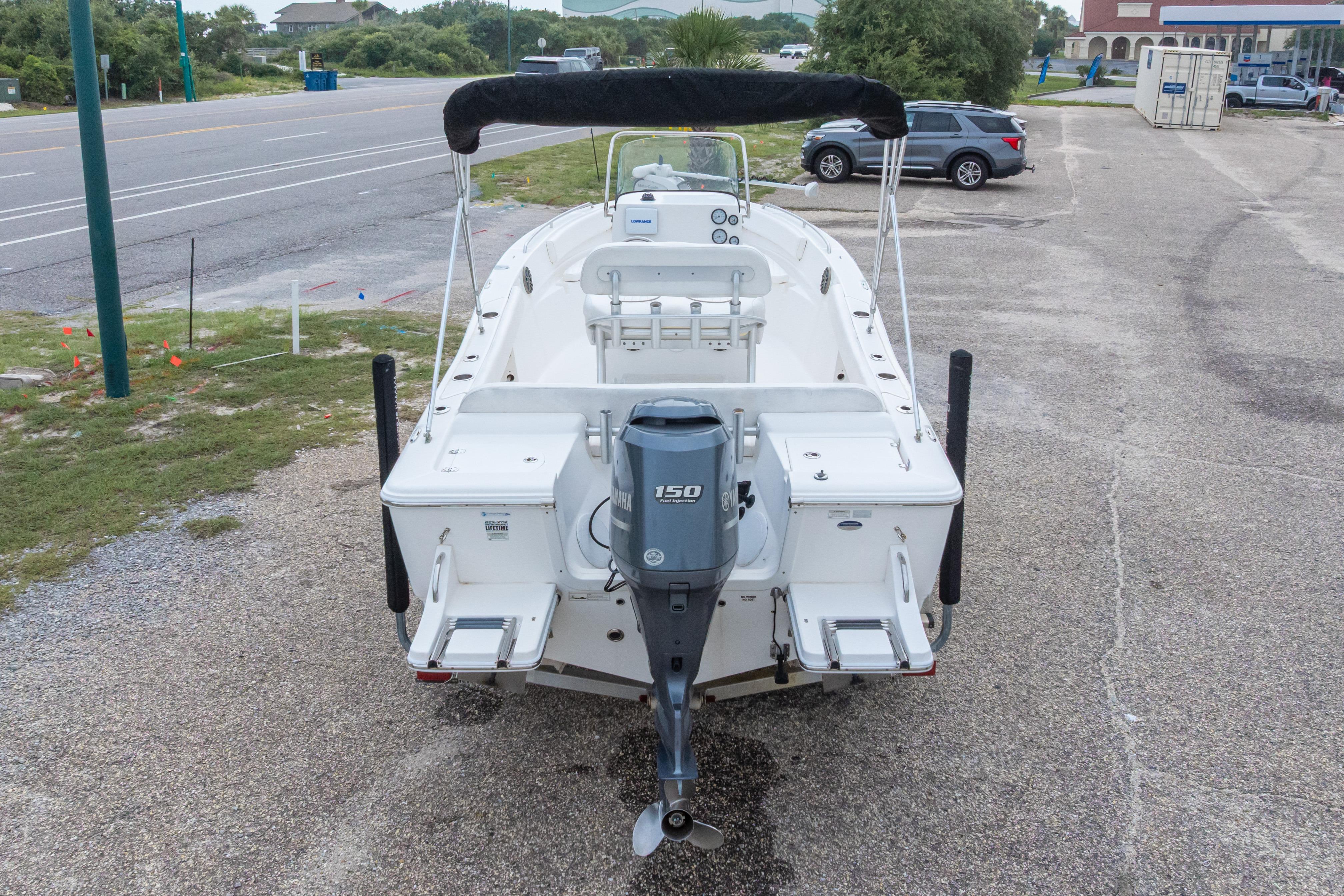 2014 Sea Fox 209 Commander boat with Yamaha 150 engine, parked on a roadside.
