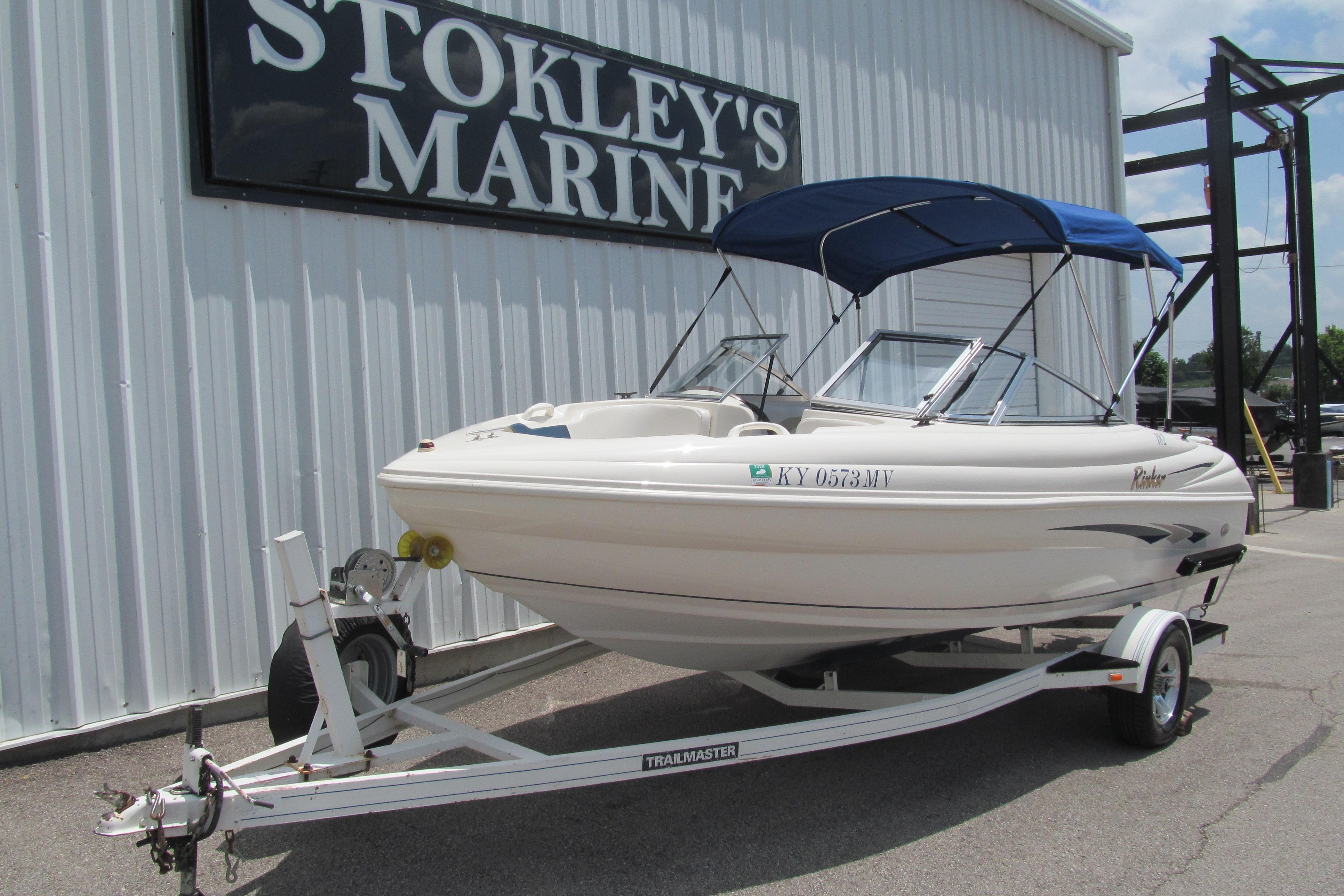 2000 Rinker boat with blue canopy on trailer at Stokley's Marine.