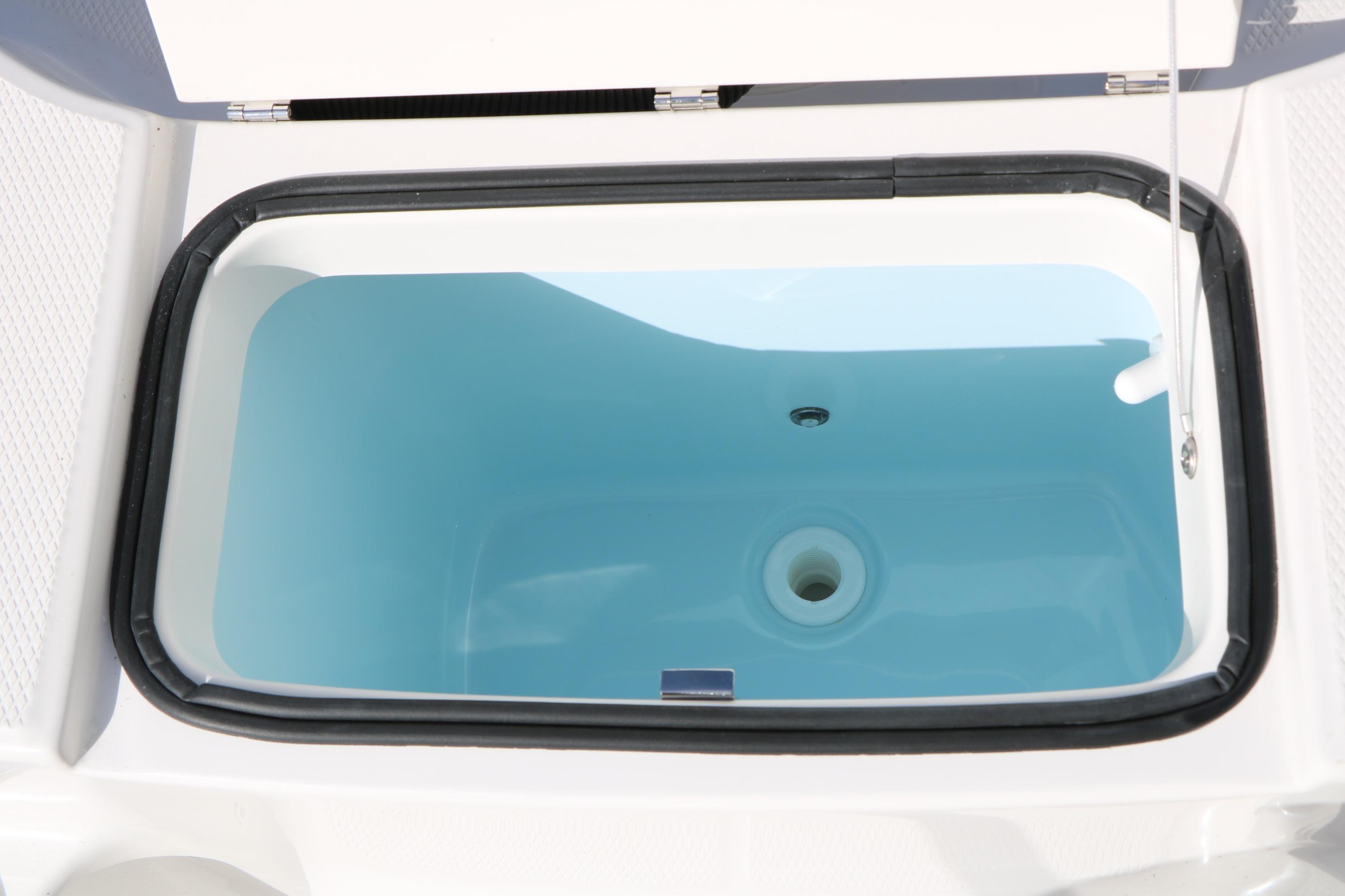 Livewell compartment on 2026 Robalo R200 Center Console boat, open lid view.