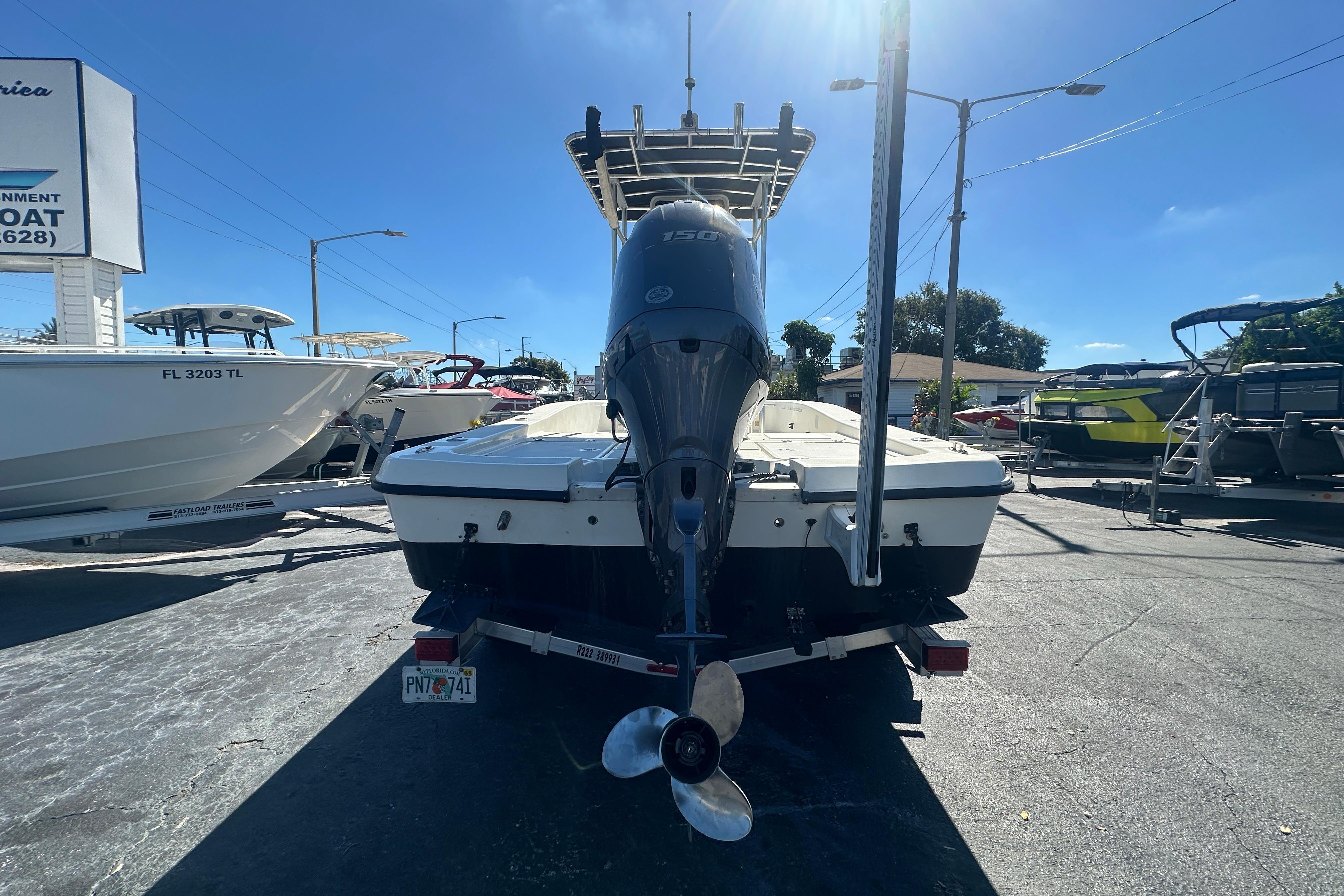 2003 Hydra-Sports 19 Bay Bolt boat with outboard motor, parked on a trailer.