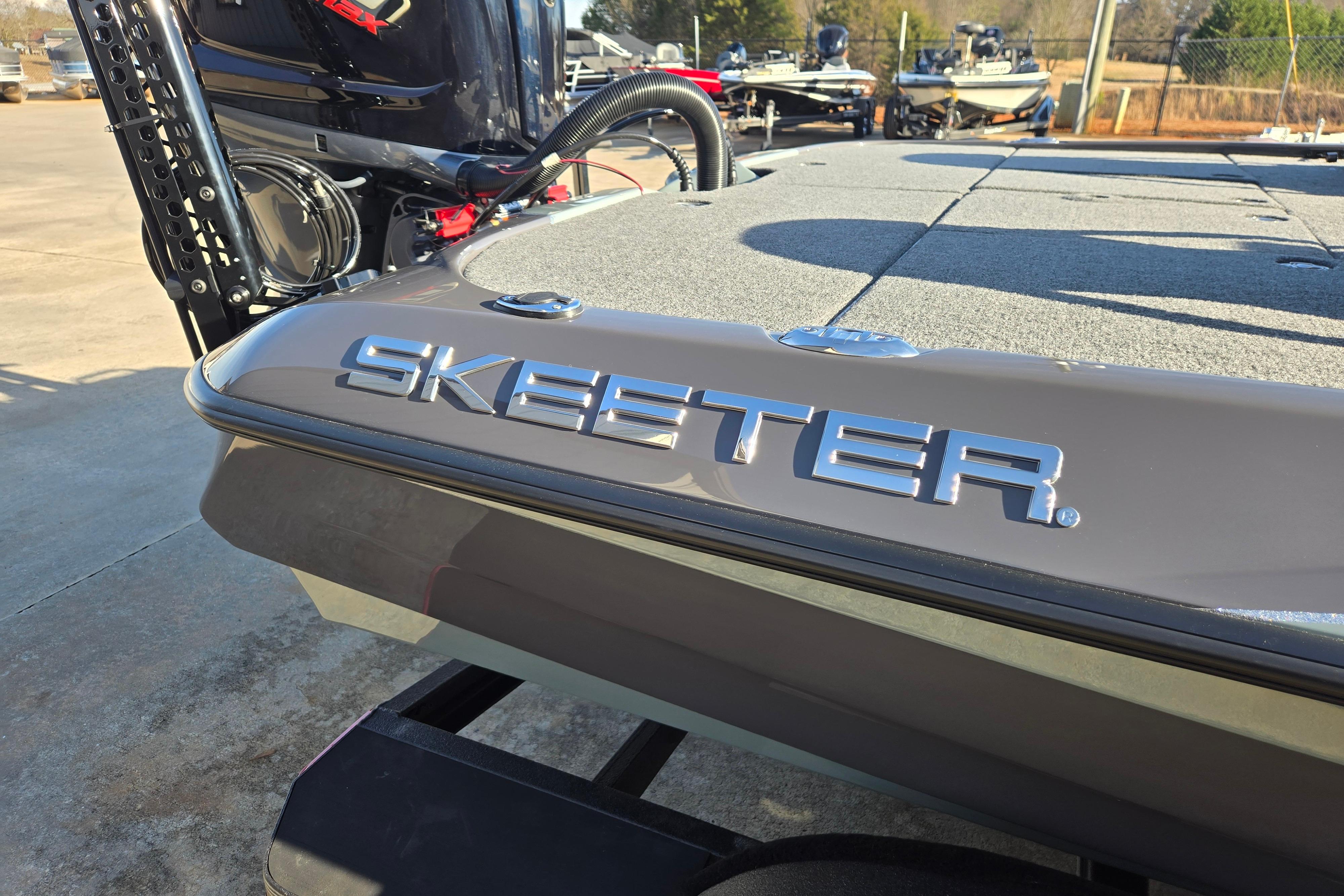 2026 Skeeter ZXE21 boat with sleek design and logo, parked outdoors.