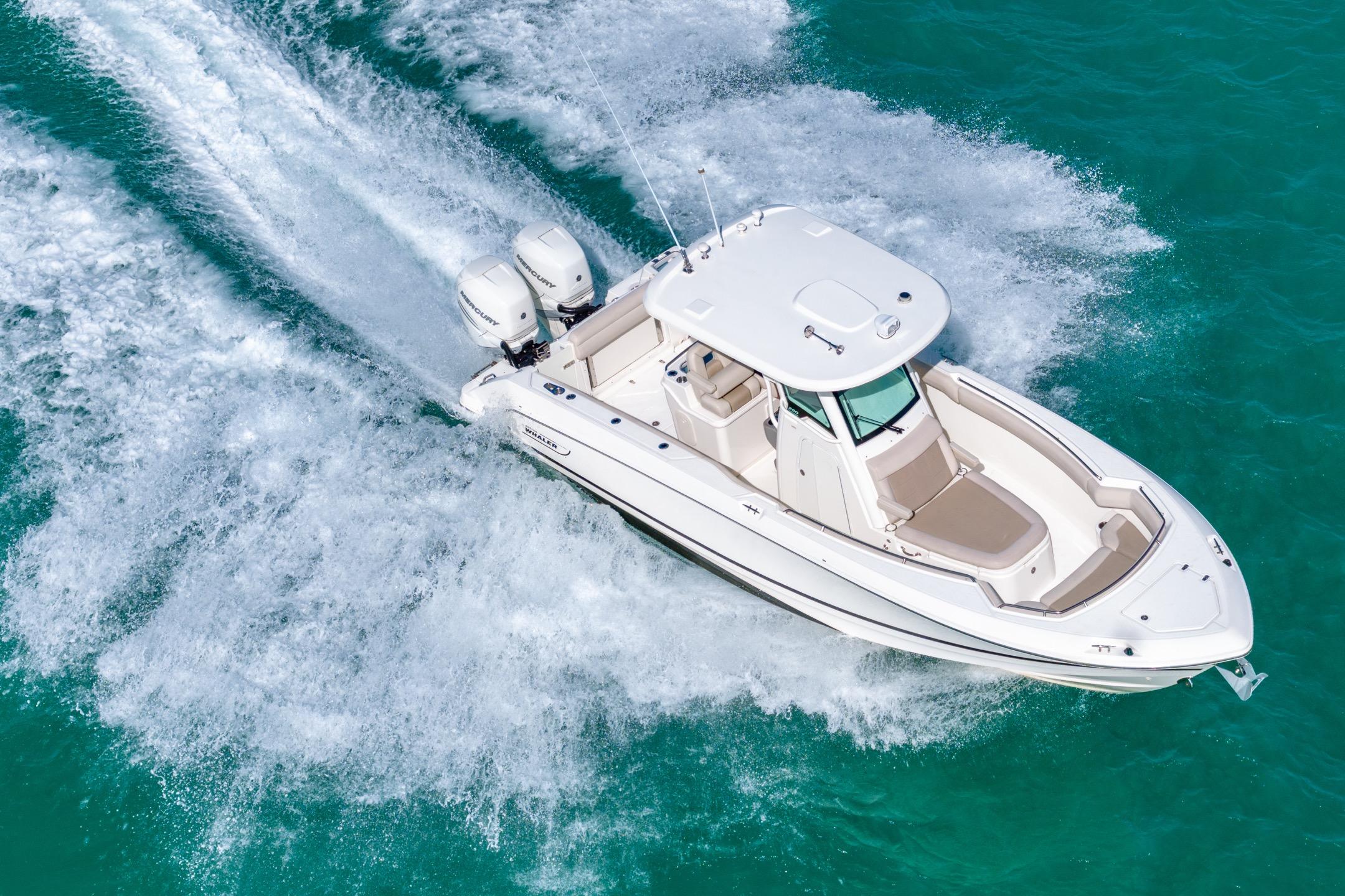 2016 Boston Whaler 280 Outrage cruising on turquoise water, aerial view.