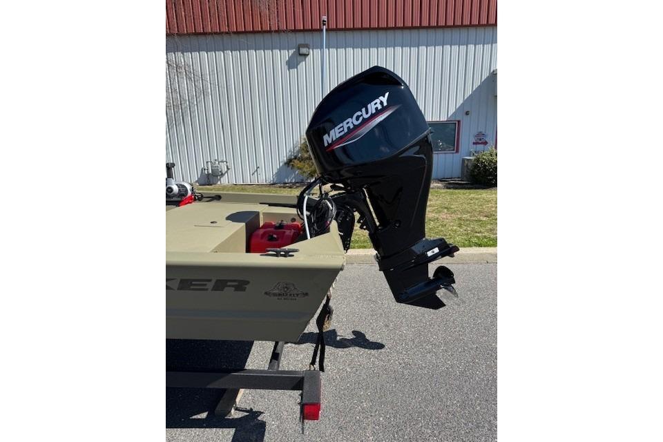 2026 Tracker Grizzly 1648 SC boat with Mercury outboard motor, parked outdoors.