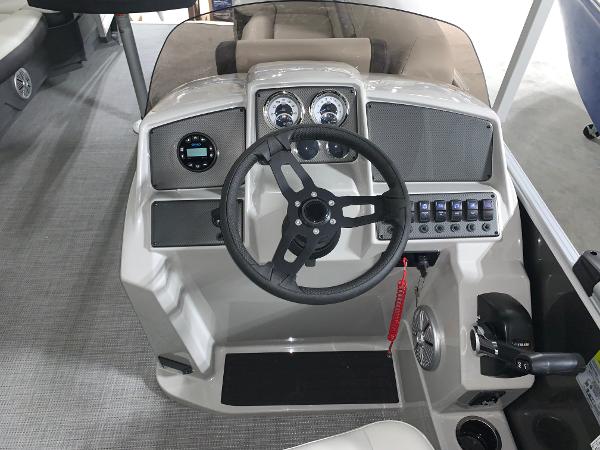 2024 Starcraft EX22 FD boat dashboard with steering wheel and control panel.