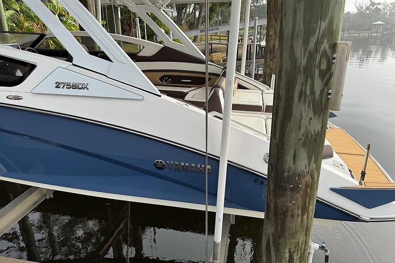 2023 Yamaha 275SDX boat docked, featuring sleek design and modern amenities.