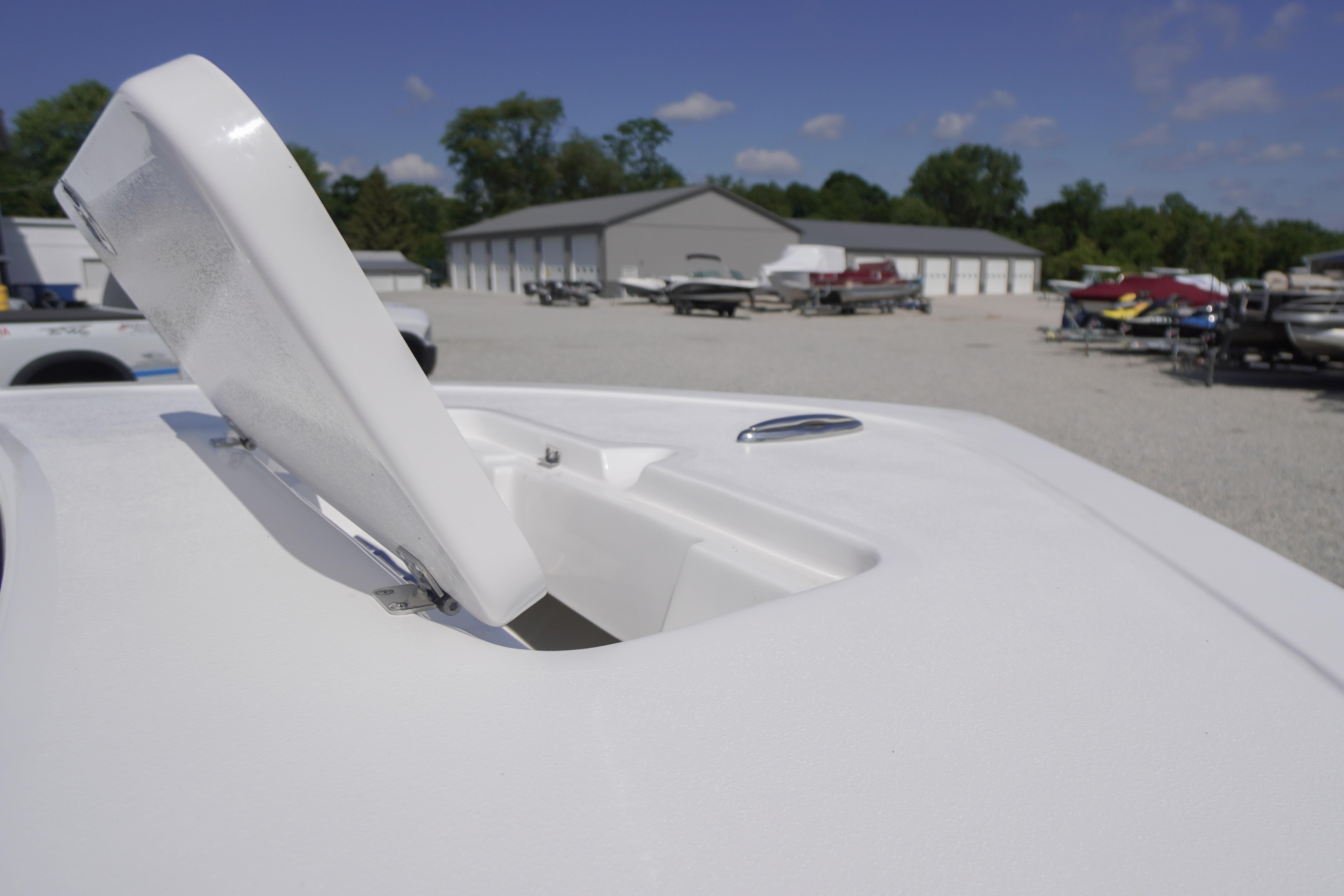 Open hatch on 2026 Tidewater 220 CC Adventure boat, with storage area visible.